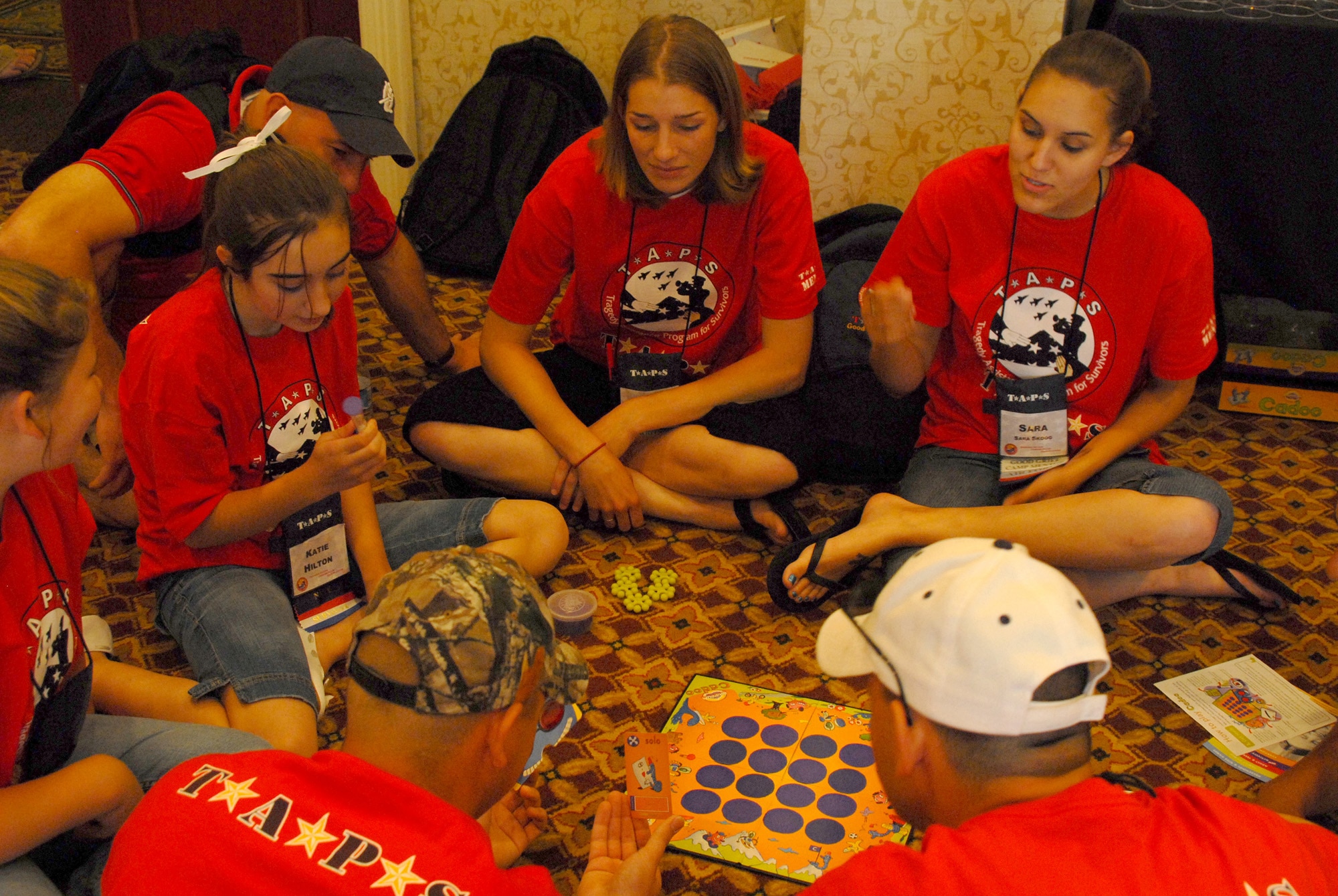 Senior Airmen Afton Thornton and Sara Skoog work with children attending the Tragedy Assistance Program for Survivors camp May 25 at Crystal City, Va. The two were mentors for the children helping them have fun by playing games, as well as talking to them during grief sessions about the loss of their loved one. Held over Memorial Day weekend, TAPS was a three-day camp children and family members who have lost a loved one in military service can attend that aims to help teach families how to grieve, as well as share their stories and make friends who share their loss. Airmen Thornton and Skoog are Air Force Honor Guard members. (U.S. Air Force photo/Staff Sgt. Madelyn Waychoff) 
