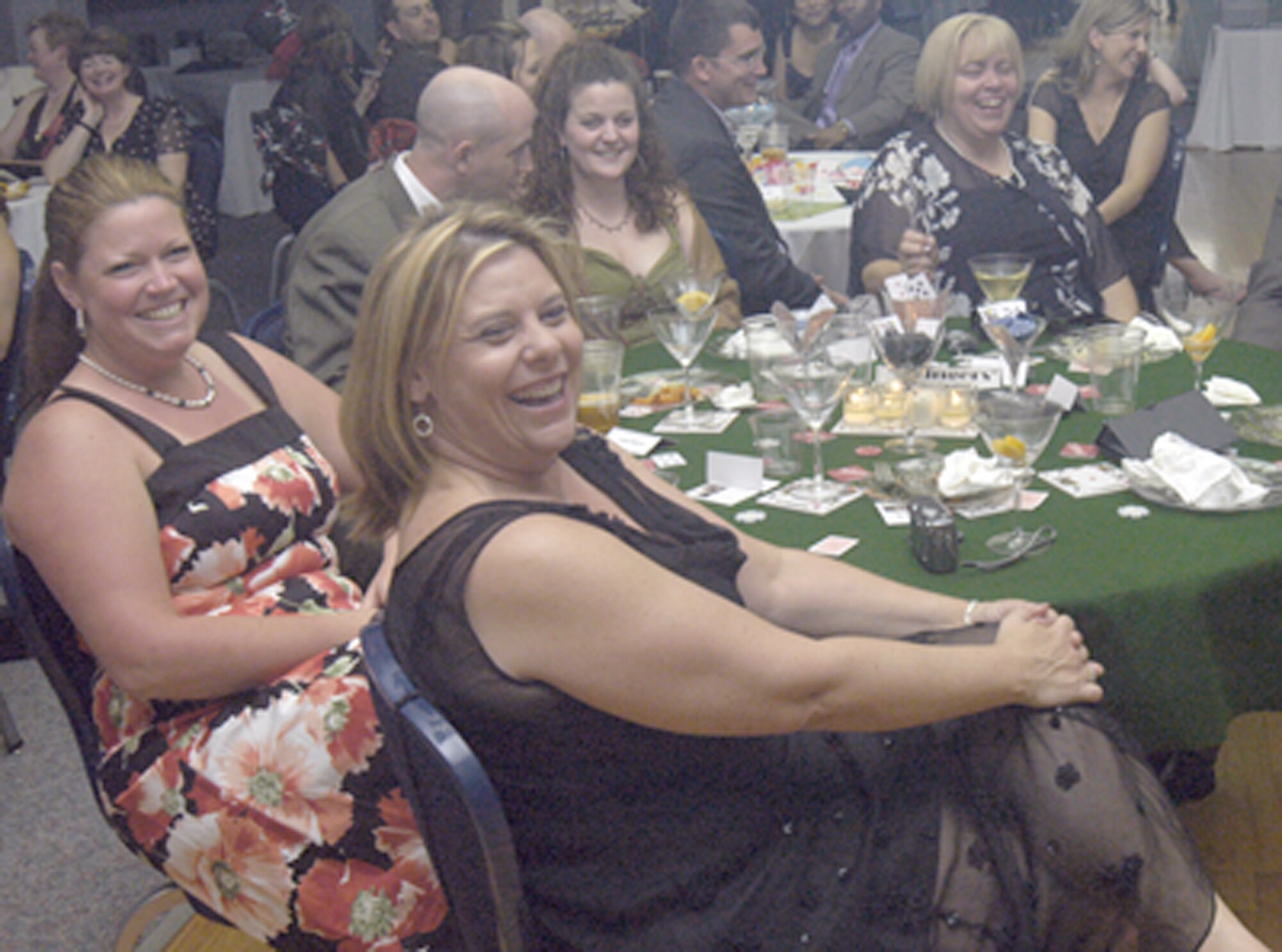 Members of the Warren Spouses Club and their spouses laugh during the skit presented by Col. Mike Carey, 90th Space Wing commander, playing himself and Lt. Col. Chris Coffelt, 321st Missile Squadron commander, playing Cindee Leonard, former president of the WSC. The WSC held their end-of-the-board-year event, “A Night at the Oscars” at the Pronghorn Center May 19 to welcome the new board members and say good-bye to the old (Photo by 2nd Lt. Lisa Meiman).