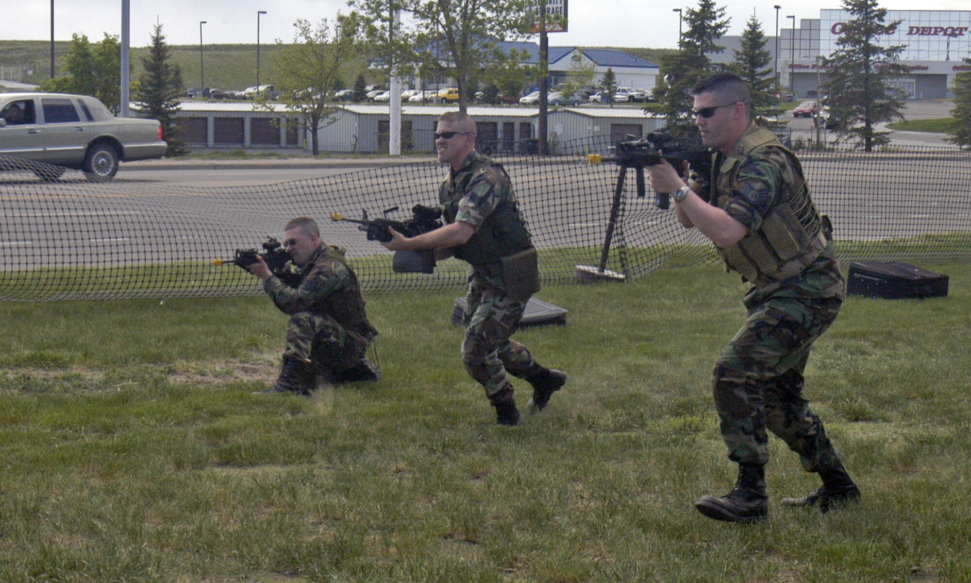 Staff Sgt. Gordon Mathis, 90th Security Support Squadron, Senior Airman Matthew Treadwell, 90th SSPTS, and Staff Sgt. Joshua Fitch, 90th SSPTS, give a small fire arms demonstration to mall-goers outside the mall May 19. The fire arms fired blanks.