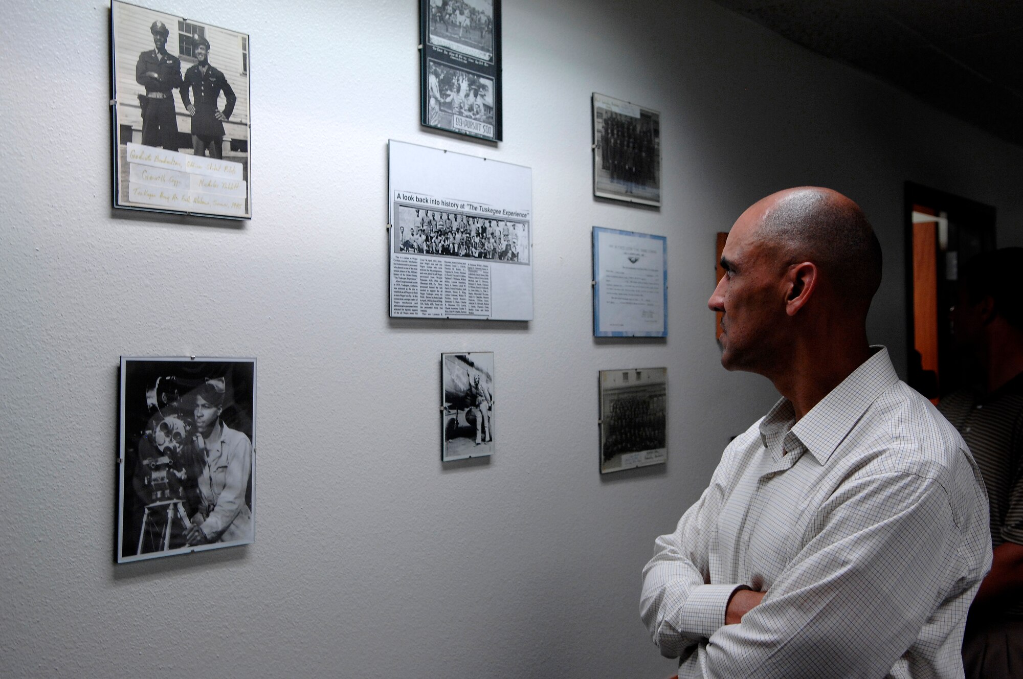Indianapolis Colts head coach Tony Dungy looks at Tuskegee Airmen memorabilia at the 560th Flying Training Squadron at Randolph Air Force Base, Texas, June 1. Colts team members spent the day visiting with base personnel and school children, enhancing the already strong relationship between the team and the Air Force. Mr. Dungy's father, Wilbur Dungy, was a Tuskegee Airman.  (U.S. Air Force photo/Staff Sgt. Brian Ferguson)
