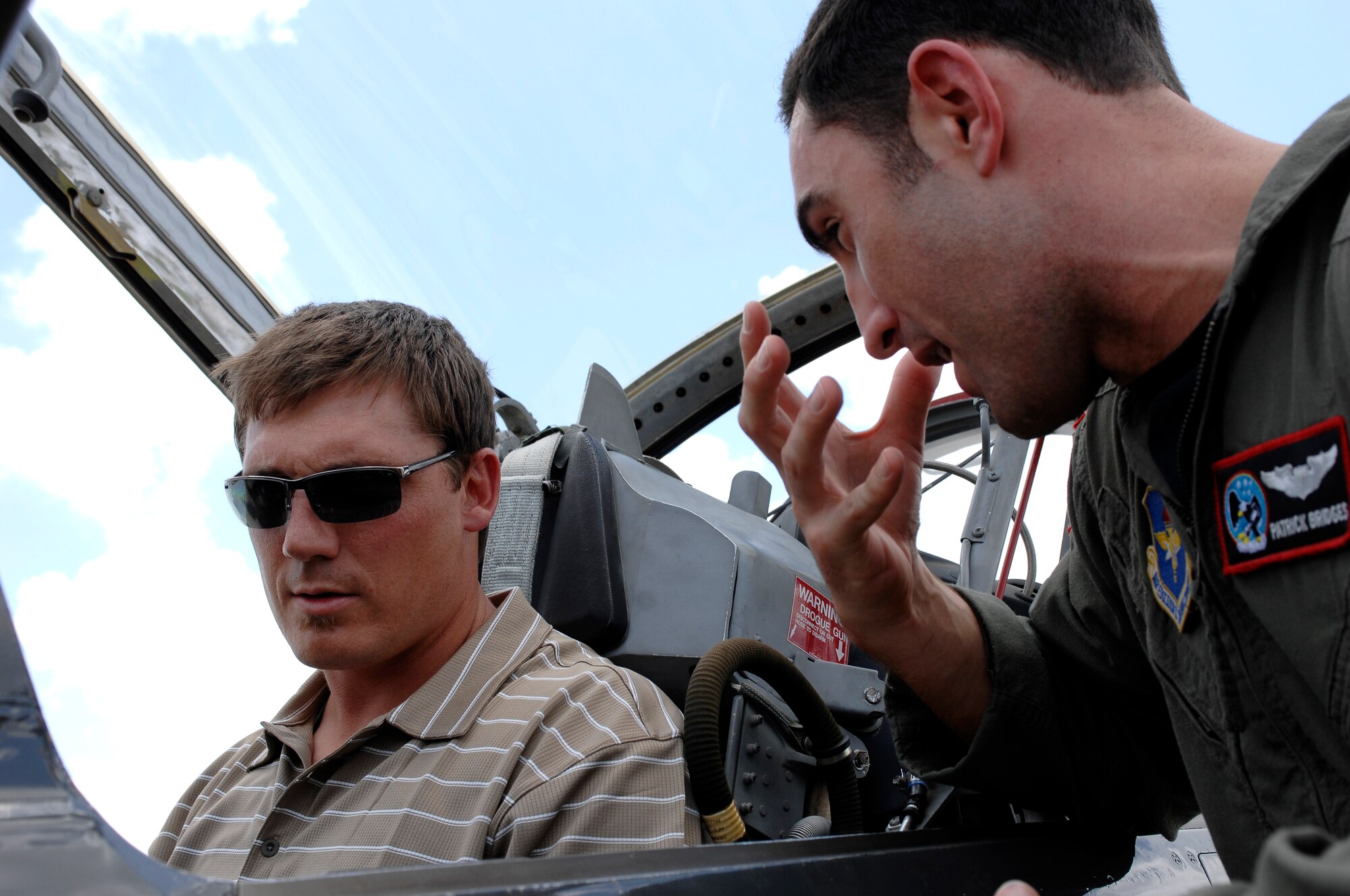 Capt. Patrick Bridges explains the cockpit of a T-38 Talon to Indianapolis Colts long snapper Justin Snow on the Randolph Air Force Base, Texas, flightline June 1. Colts team members spent the day visiting with base personnel and school children, enhancing the already strong relationship between the team and the Air Force.  (U.S. Air Force photo/Staff Sgt. Brian Ferguson)
