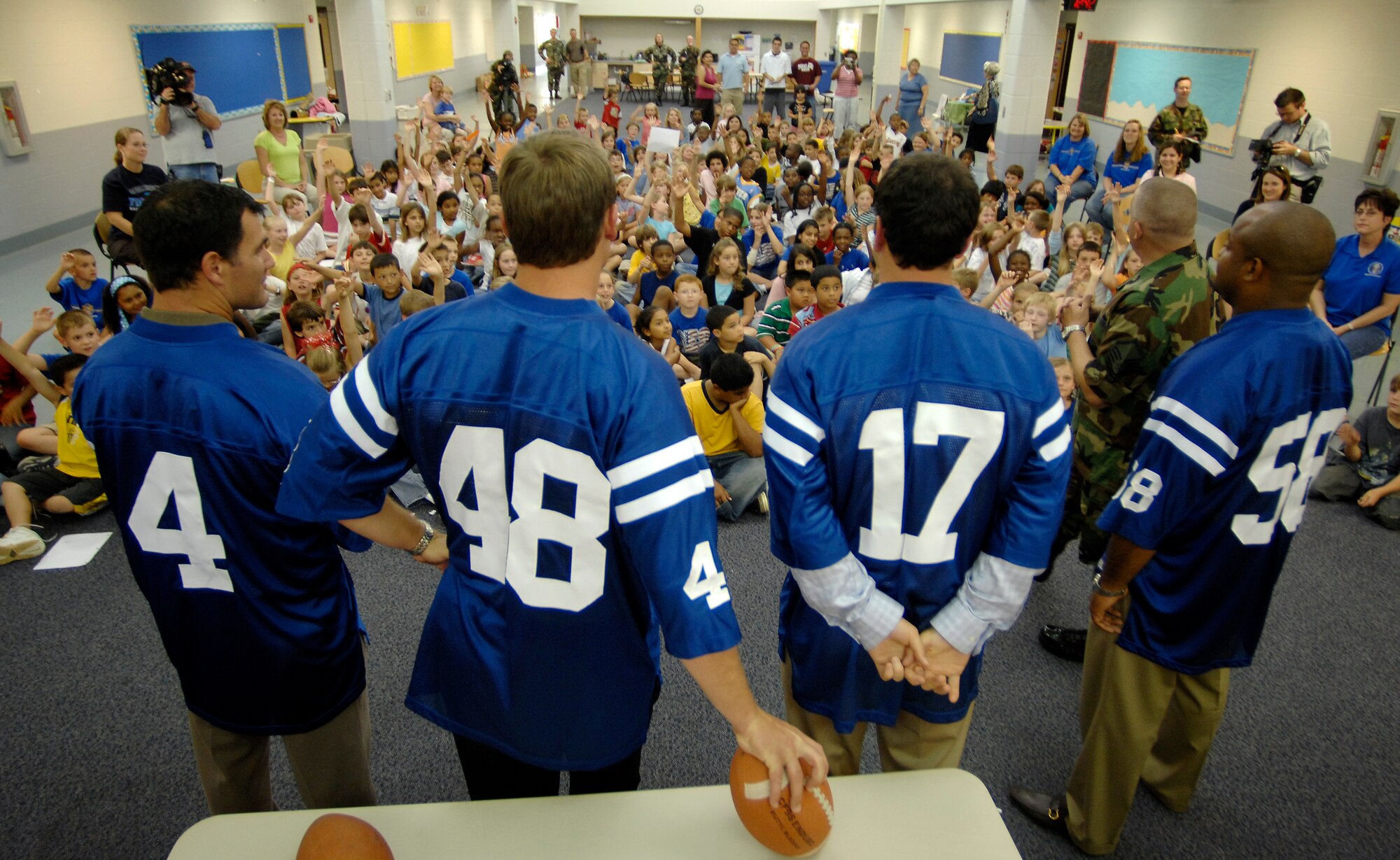 Indianapolis Colts (left to right) Adam Vinatieri, Justin Snow, Hunter Smith and Gary Brackett talk to kids at Randolph Elementary School on Randolph Air Force Base, Texas, June 1. Colts team members spent the day visiting with base personnel and school children, enhancing the already strong relationship between the team and the Air Force.  (U.S. Air Force photo/Staff Sgt. Brian Ferguson)
