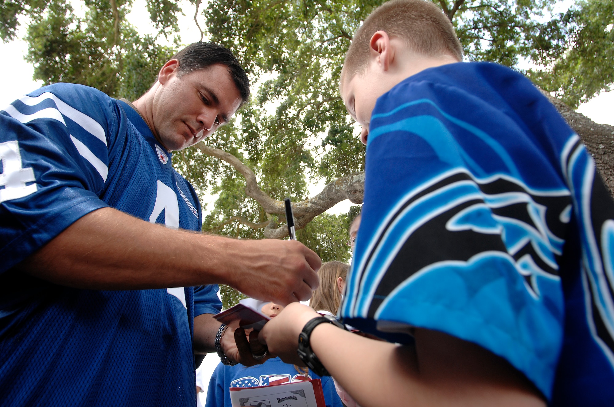 Indianapolis Colts kicker Adam Vinatieri signs an autograph for a student at Randolph Elementary School on Randolph Air Force Base, Texas, June 1. Colts team members spent the day visiting with base personnel and school children, enhancing the already strong relationship between the team and the Air Force.  (U.S. Air Force photo/Staff Sgt. Brian Ferguson)
