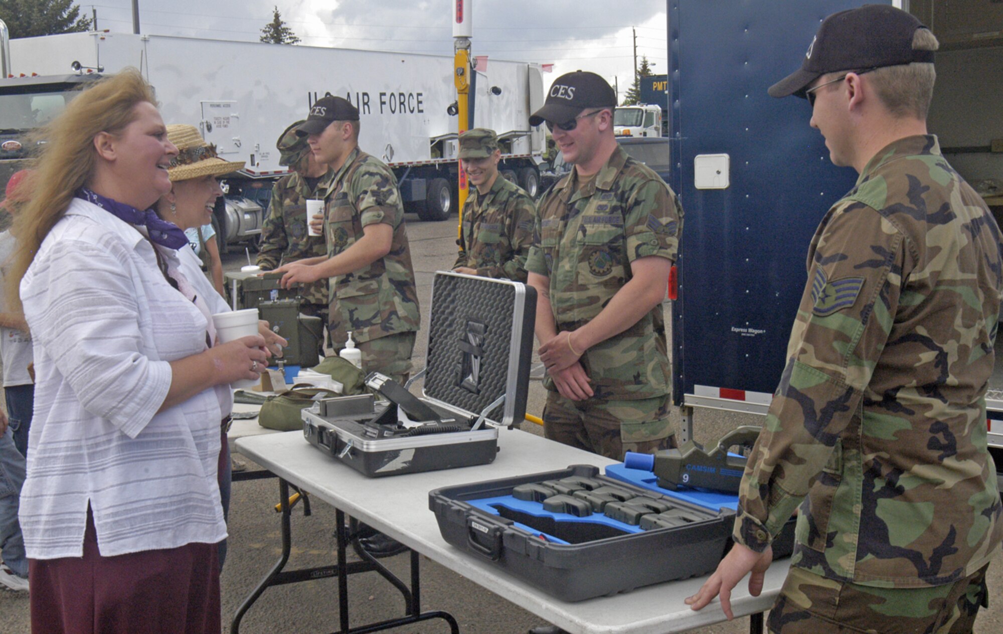 Members of the 90th Civil Engineering Squadron talk to local residents about the mobile command post and its equipment.