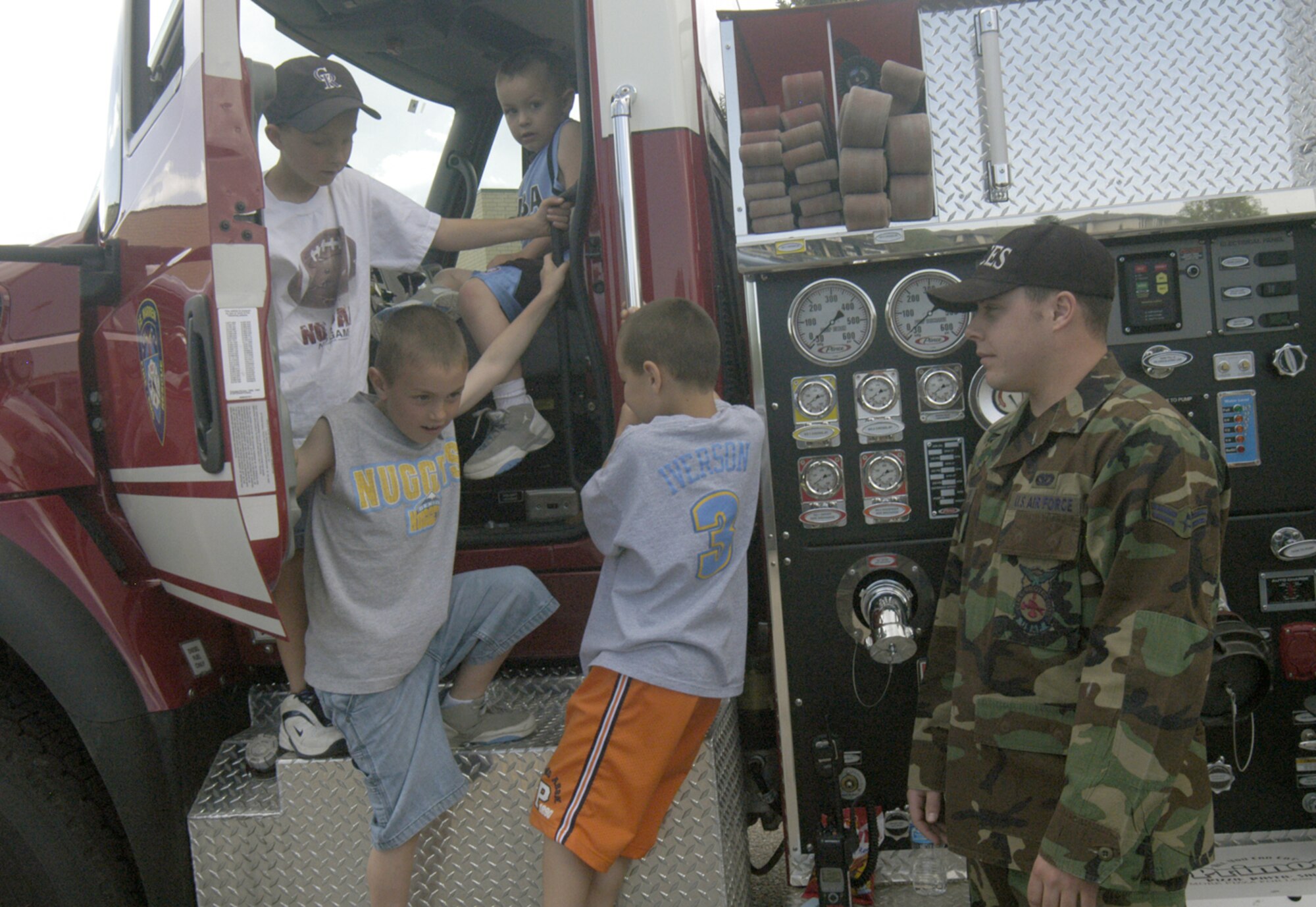 Local children explore a Warren fire department tanker truck May 19 outside Frontier Mall. Airman 1st Class Josh Livingston, WFD, supervises and educates the children on how the truck works. In celebration of Armed Forces Day, service members of all services set up static displays and information booths inside and outside the Frontier Mall to show local residents their respective mission and capabilities.