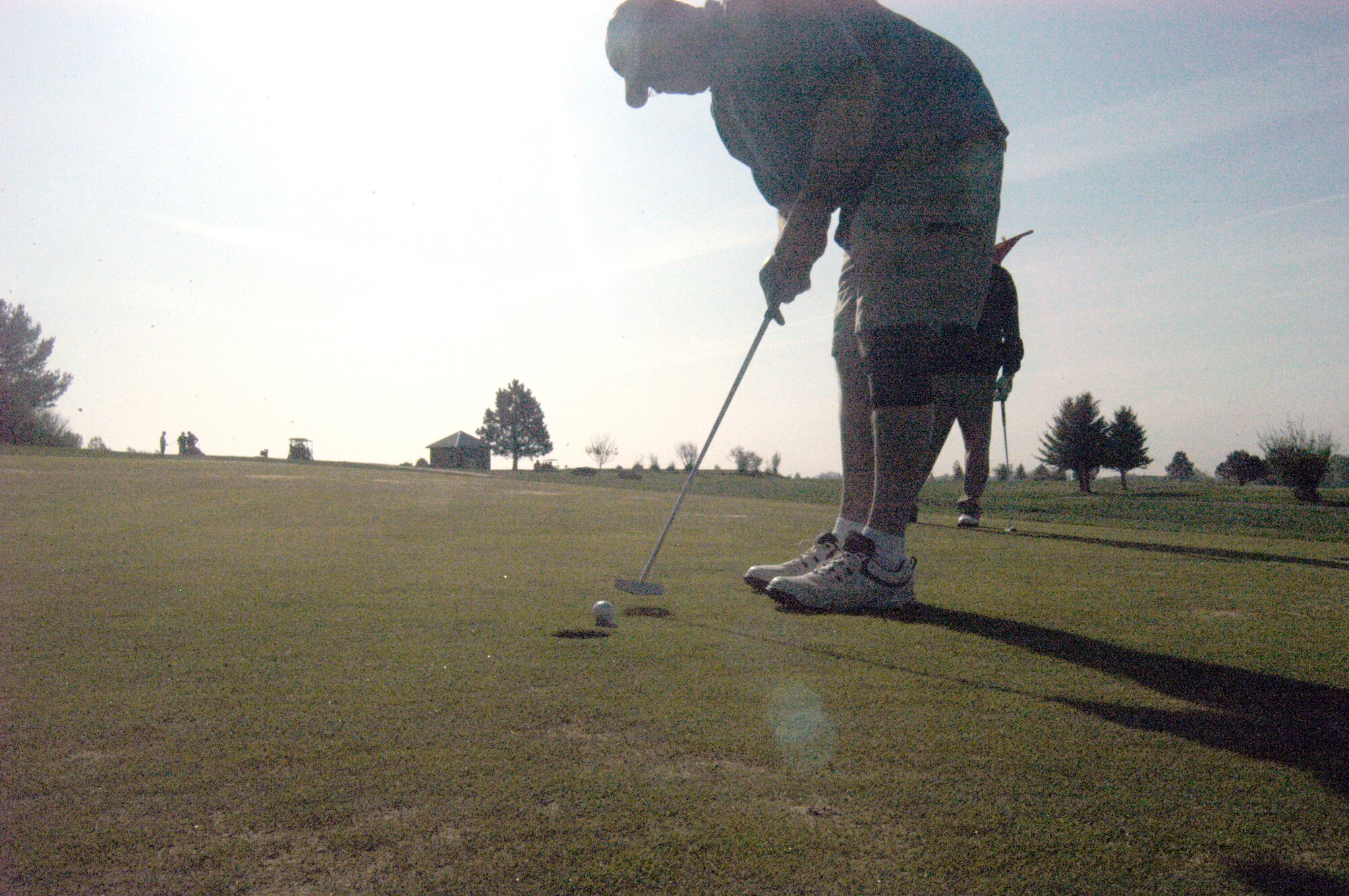 Master Sgt. Dave Brayman, 790th Missile Security Forces Squadron, sinks a putt at the Warren golf course May 17 during the 90th Security Forces Group National Police Week golf tournament. More than 70 people, some from fire and police departments as far away as Casper and Laramie, Wyo., golfed in teams of three and four in the golfing competition. The winning team consisted of Mark Ragsdale, 90th Space Wing; Senior Master Sgt. Sammy Gardner, 90th Security Forces Group; and Bill Hinz and Randy Reiling, both from the Cheyenne fire department (Photo by 2nd Lt. Lisa Meiman).