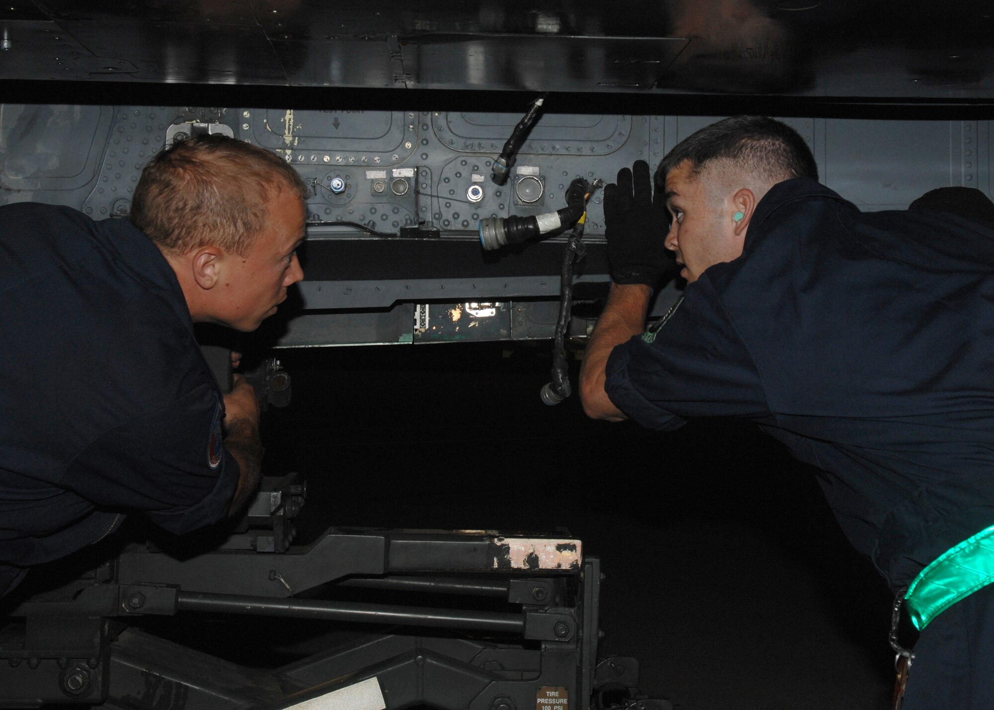 SEYMOUR JOHNSON AIR FORCE BASE, N.C. - Senior Airman Phil Benson (left) and Staff Sergeant Warren Johnson (right) install a conformal fuel tank on a F-15E Strike Eagle, May 30. The 4th Fighter Wings mission requires that the Strike Eagles are ready to deliver air power on target, on time whenever America calls. Therefore Airmen of the 4th Maintenance Group maintain these jets 24 hours per day. (U.S. Air Force photo by Senior Airman Christine Fortin)