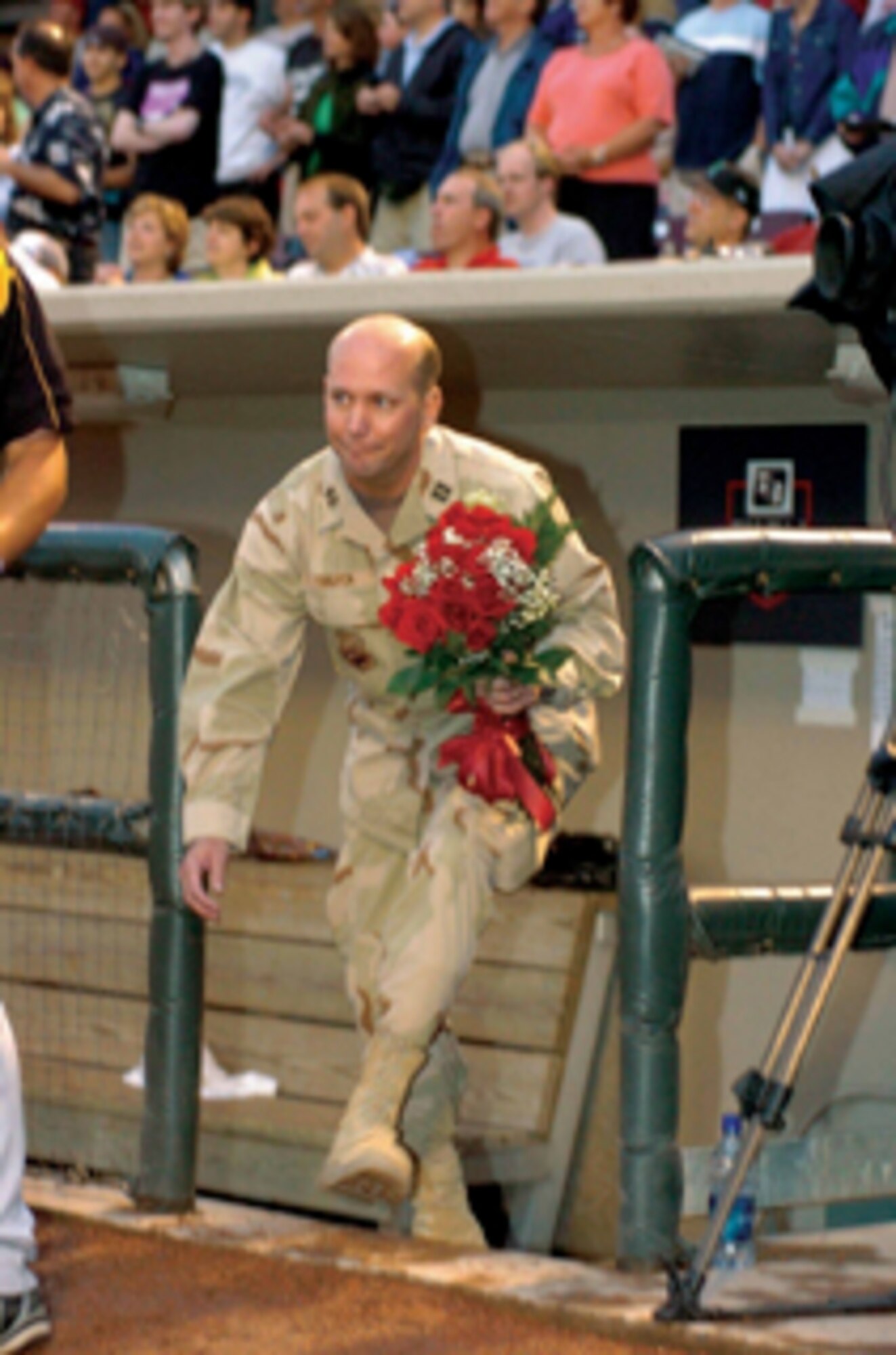 Having kept his return from a Middle East deployment under wraps, Capt. Jim Thigpen makes his way toward his unsuspecting family during the Dayton Dragons game at Fifth Third Field in Dayton, Ohio. (Photo courtesy of the Dayton Dragons)

