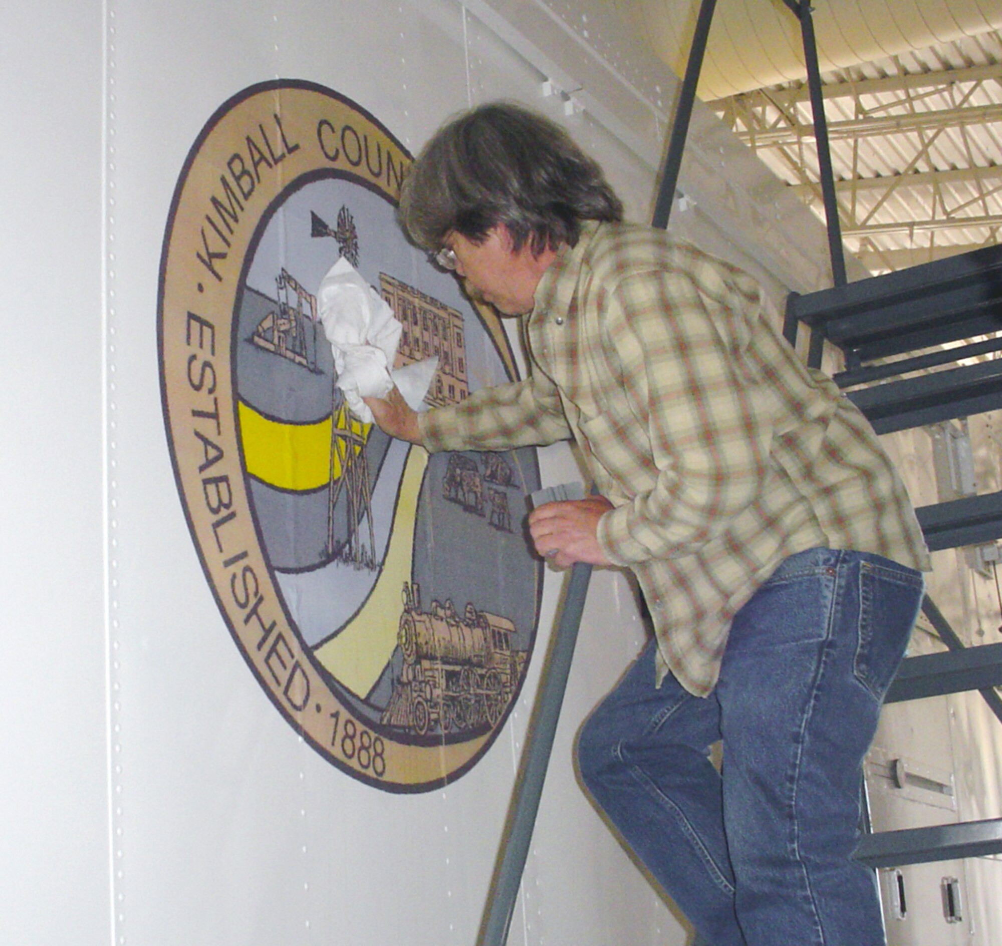 Tom Dunbar, 90th Civil Engineer Squadron sign shop, paints new “nose art” on the 90th Maintenance Group payload transporters May 8. The nose art is an opportunity for the 90th Space Wing and 90th MXG to recognize local communities and thank them for their support. The new sets include one recognizing Kimball County, Neb., and another highlighting the 60th Anniversary of the Air Force (Photo by 2nd Lt. James Gutierrez).