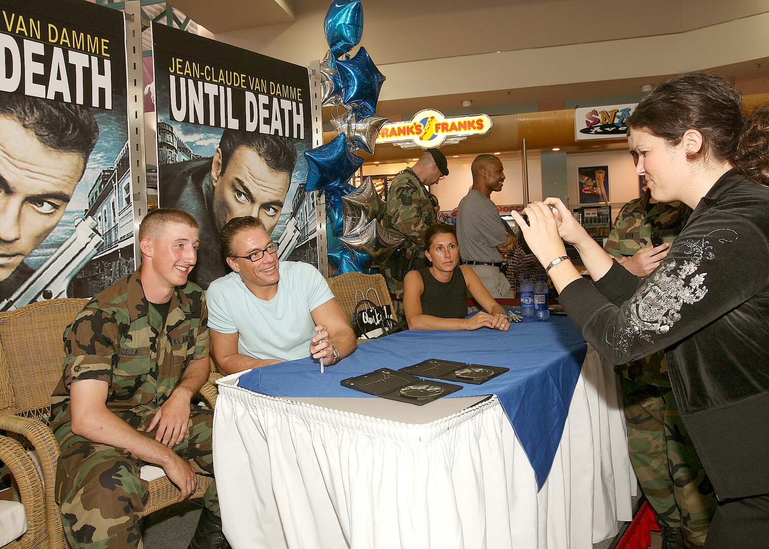 Airman Basic Mathew Cella strikes a pose with actor Jean-Claude Van Damme while having his picture taken June 2 at the base exchange at Lackland Air Force Base, Texas. Mr. Van Damme signed autographs and posed for photos with base members. Airman Cella is a security forces technical training student with the 343rd Training Squadron at Lackland AFB. (U.S. Air Force photo/Robbin Cresswell) 
