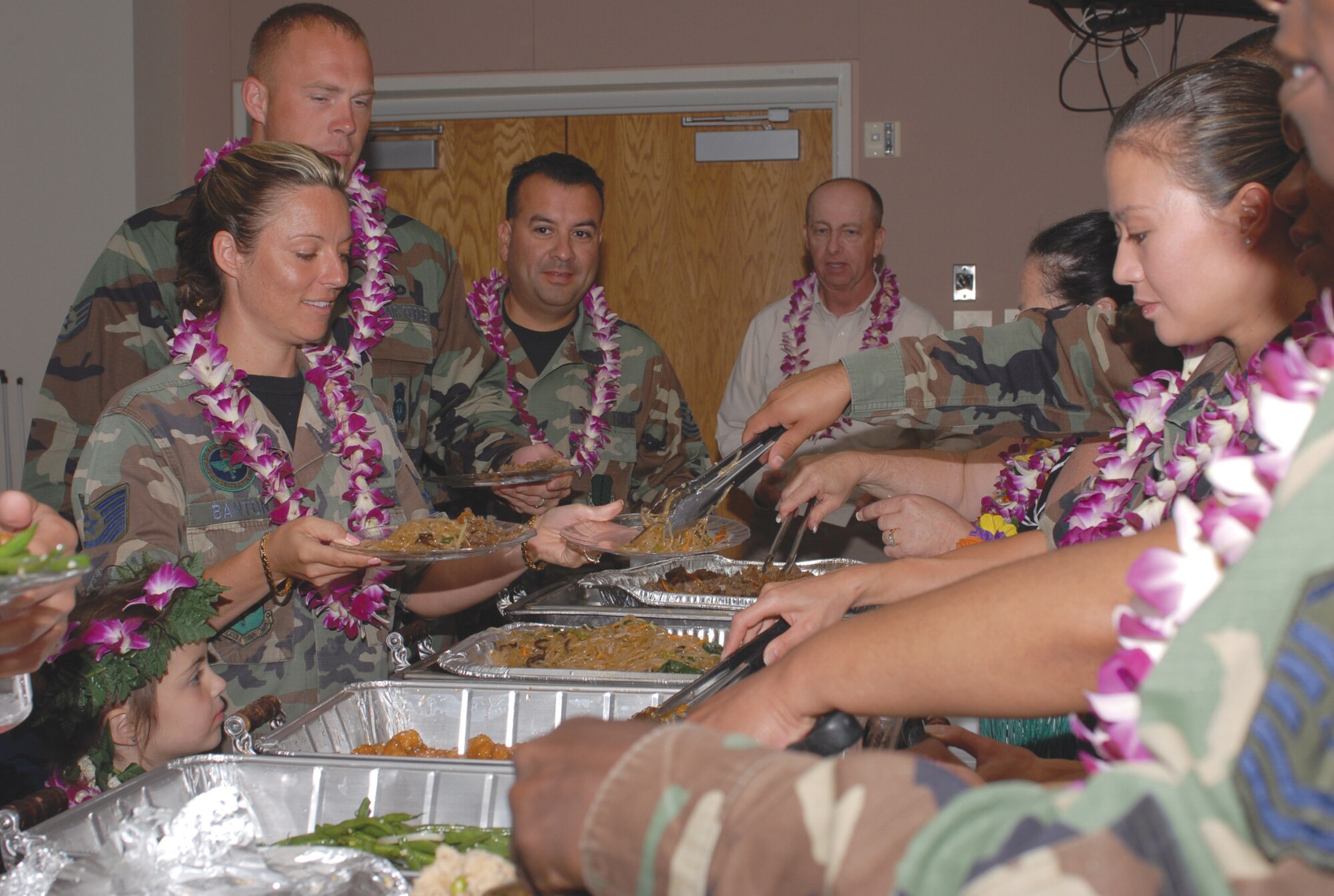 Guests at the 2007 Asian / Pacific Islander Heritage Luncheon treat themselves to a buffet-style menu of meals common to Asian and Pacific Islander cultures, such as fried rice, beef bulgogi and kim chee. (U.S. Air Force photo by Staff Sgt. Angela Malek)