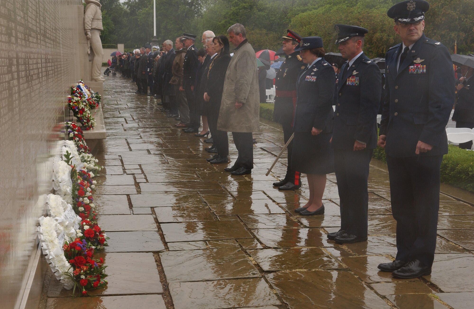 During the annual Memorial Day ceremony, Col. Michael S. Stough, 100th Air Refueling Wing commander, presents a wreath in front of the wall displaying the names of 5,126 Americans who gave their lives during World War II. Colonel Stough was one of 120 wreath presenters. (Air Force photo by Tech. Sgt. Tracy L. DeMarco)