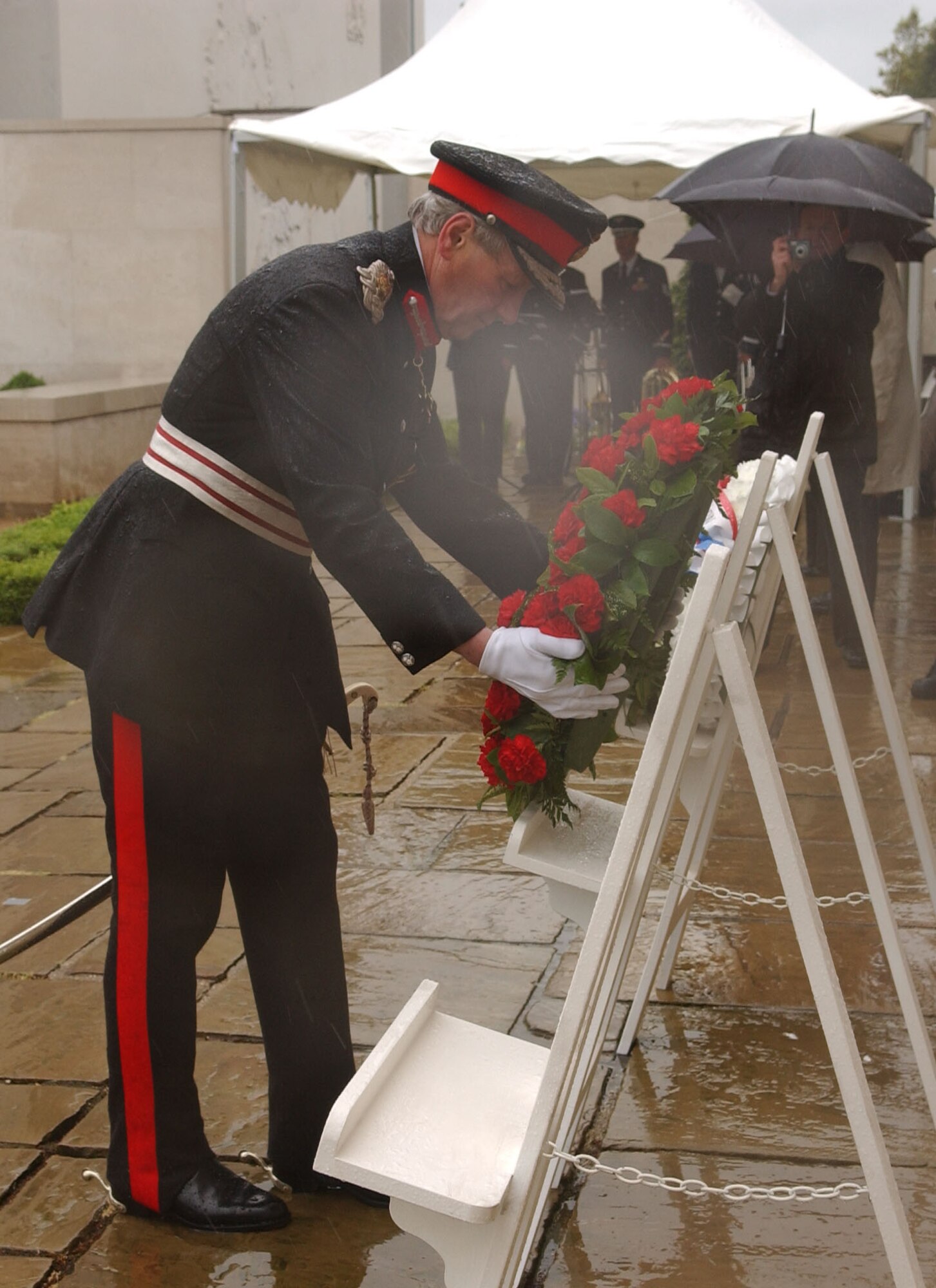 During the annual Memorial Day ceremony, Her Majesty's Lord Lieutenant Hugh Duberly of Cambridgeshire presents a wreath in front of the wall displaying the names of 5,126 Americans who gave their lives, but whose remains were never recovered or identified. (Air Force photo by Tech. Sgt. Tracy L. DeMarco)