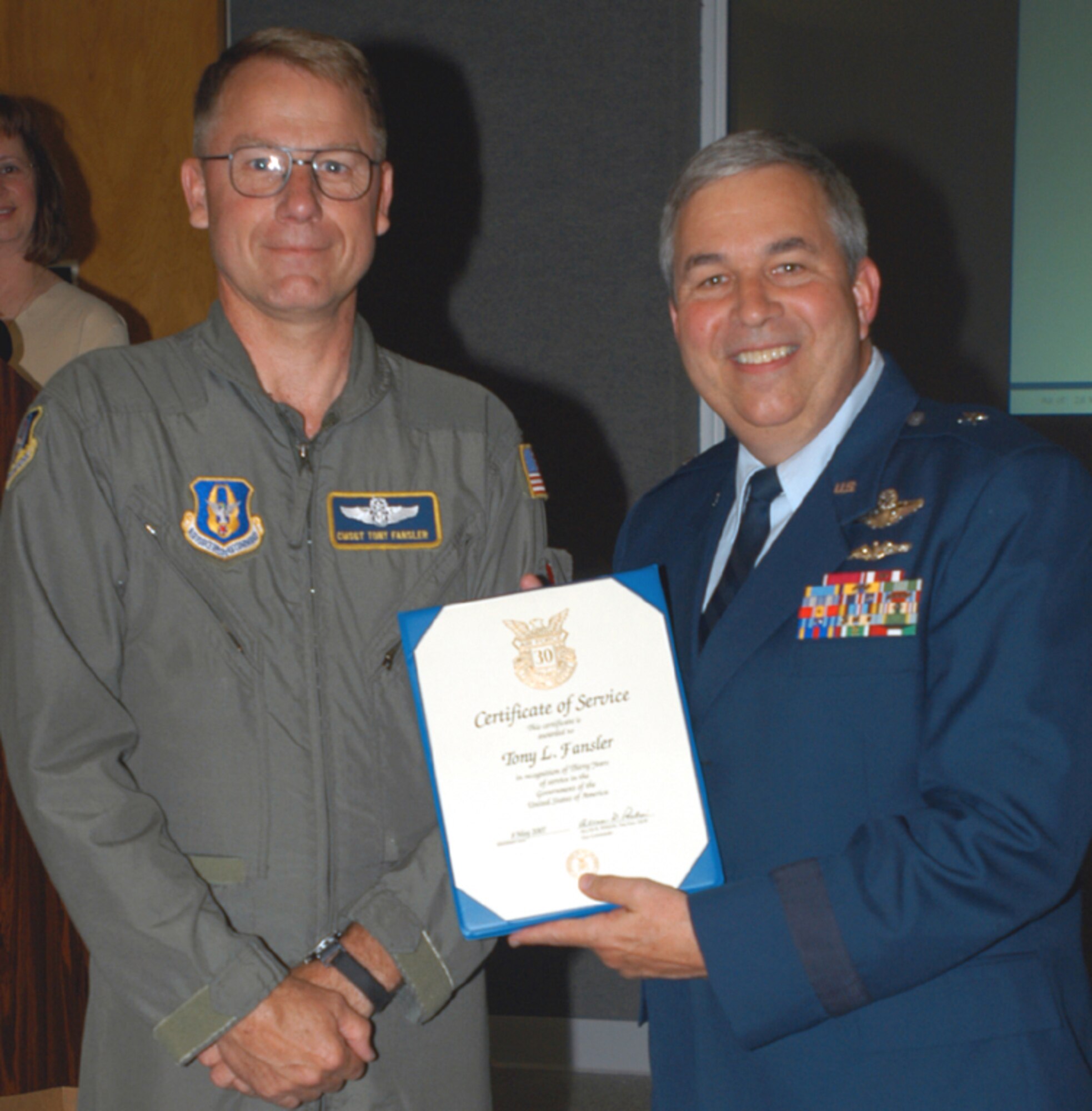 GRISSOM AIR RESERVE BASE, Ind., -- Chief Master Sgt. Tony Fansler, 72nd Air Refuelng Squadron, left, receives a pin and certificate marking 30-years of civil service from Brig. Gen. Dean Despinoy, 434th Air Refueling Wing commander. The presentation was made during a special civilian commander's call. (U.S. Air Force photo/Tech. Sgt. Doug Hays)
