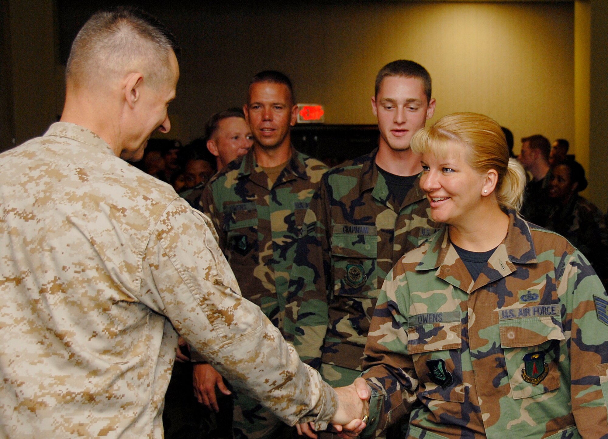 ANDERSEN AIR FORCE BASE, Guam - Chairman of the Joint Chiefs of Staff U.S. Marine Gen. Peter Pace presents his coin to Tech. Sgt. Kimberly Owens, 36th Communications Squadron June 1 at the base theater. During his brief stay at Andersen, General Pace held a town hall meeting to thank servicemembers and answer their questions and concerns. (U.S. Air Force photo/Airman 1st Class Daniel Owen)