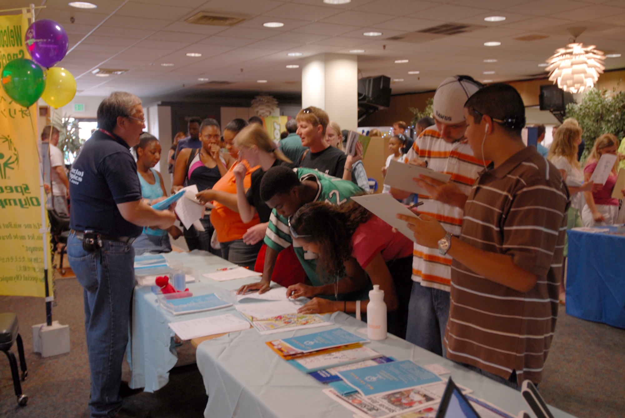 Teens gather at the Special Olympics table to volunteer for this year’s event during the teen town hall meeting June 2 at Kadena Air Base, Japan. The meeting gave teens and their parents information on what activities are available for them during their summer vacation.
(U.S. Air Force/Airman 1st Class Kasey Zickmund)