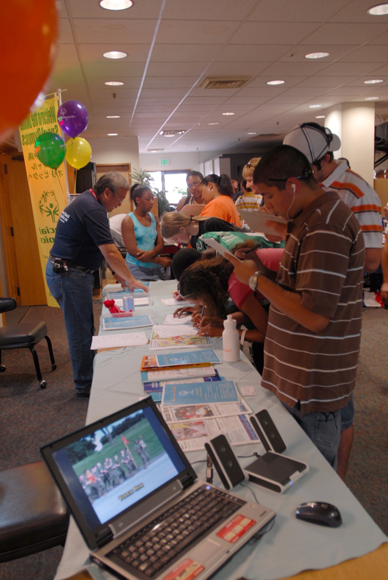 Teens gather at the Special Olympics table to volunteer for this year’s event during the teen town hall meeting June 2. The meeting gave teens and their parents information on what activities are available for them at Kadena Air Base, Japan, during their summer vacation.
(U.S. Air Force/Airman 1st Class Kasey Zickmund)