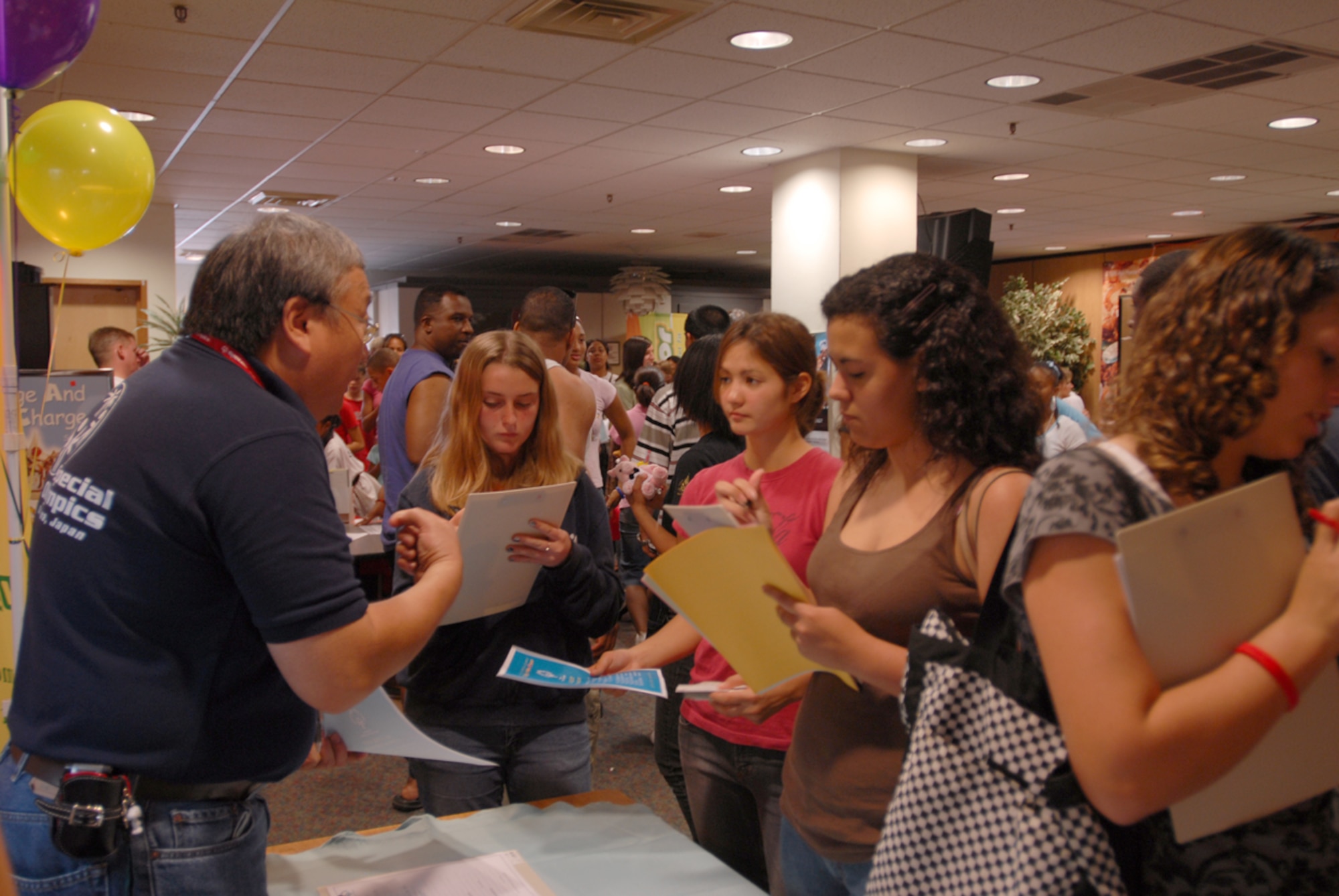Art Arao (left) speaks to Haley Cresap (left center), Rachel Burns (right center), and Cristina Vasquez (right) about volunteering for the Special Olympics during the teen town hall meeting June 2 at Kadena Air Base, Japan. The meeting gave teens and their parents information on what activities are available for them during their summer vacation.
(U.S. Air Force/Airman 1st Class Kasey Zickmund)
