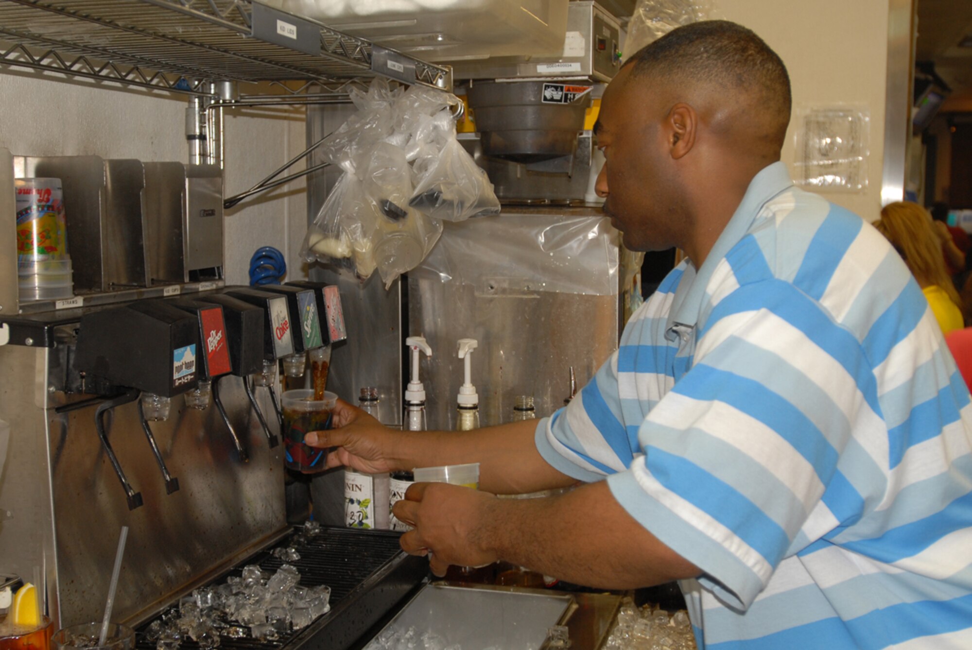 Staff Sgt. Ryan Ward, 18th Security Forces Squadron, fills drink orders for customers at Chili’s on Kadena Air Base, Japan, during the “Tip-a-Cop” fundraiser for Special Olympics June 2. Sergeant Ward was one of 42 military police members from all branches of service to volunteer for the event that raised more than 2,500 dollars.
(U.S. Air Force/Airman 1st Class Kasey Zickmund)