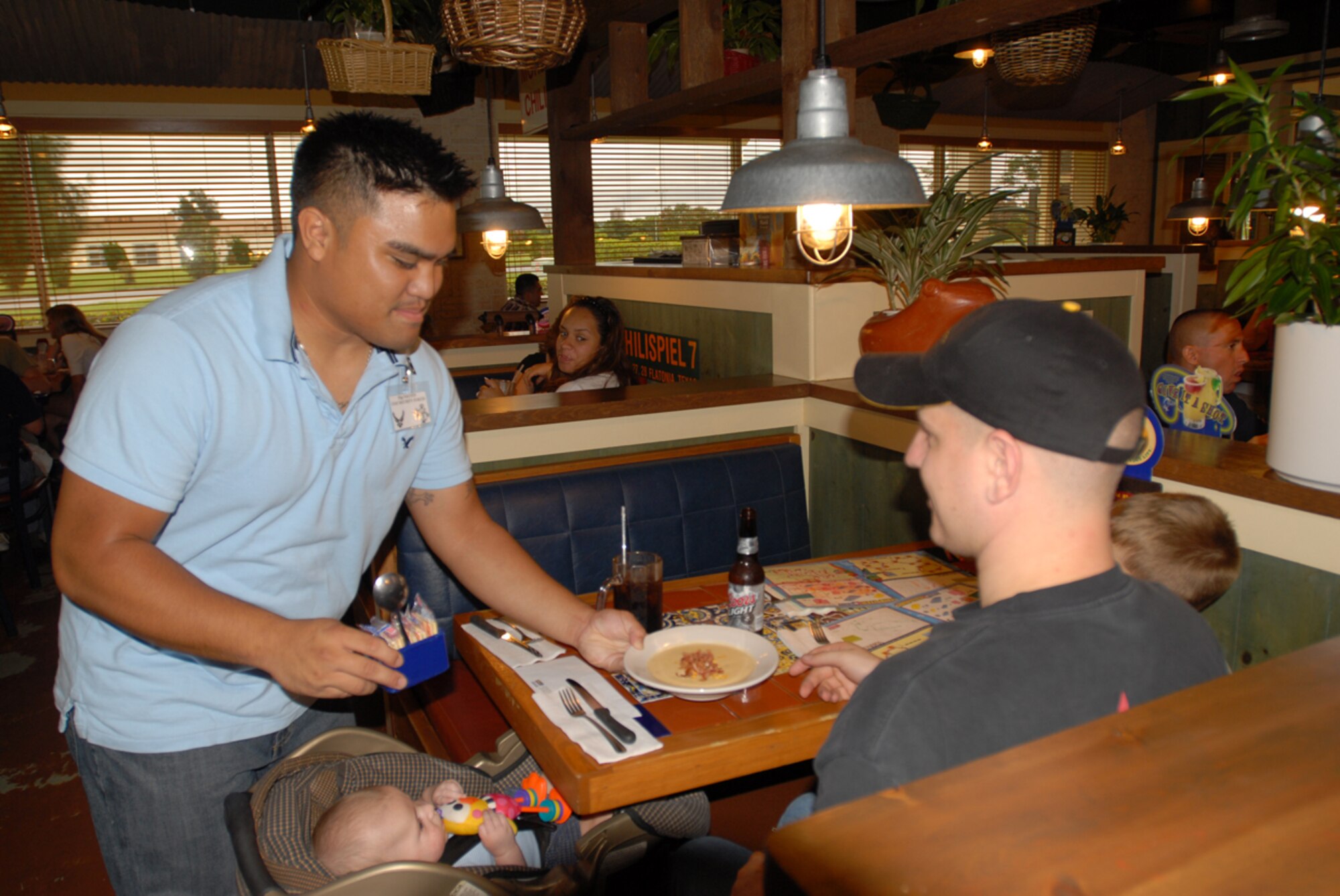 Staff Sgt. Chris Nguyen, 18th Security Forces Squadron, brings soup to a customer at Chili’s on Kadena Air Base, Japan, during the “Tip-a-Cop” fundraiser for Special Olympics June 2. Sergeant Nguyen was one of 42 military police members from all branches of service to volunteer for the event that raised more than 2,500 dollars.
(U.S. Air Force/Airman 1st Class Kasey Zickmund)