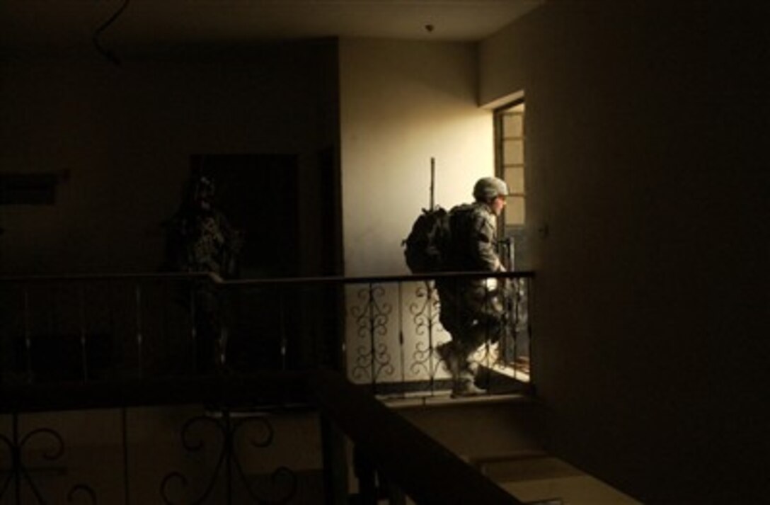 A U.S. Army soldier goes out into the daylight as he searches a house in Rashid, Iraq, on June 2, 2007.  The soldier is attached to Alpha Company, 2nd Battalion, 3rd Infantry Regiment.  