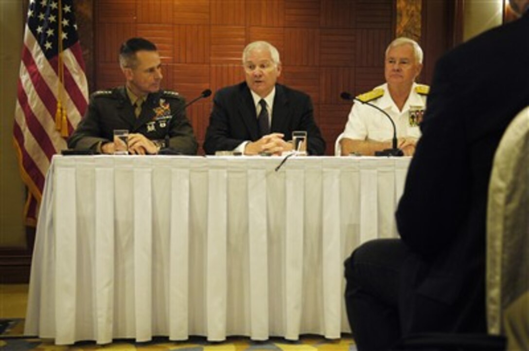 Secretary of Defense Robert M. Gates (center) answers a reporter's question during a press conference in Singapore on June 2, 2007.  Chairman of the Joint Chiefs of Staff Gen. Peter Pace (left), U.S. Marine Corps, and Commander of U.S. Pacific Command Adm. Tim Keating, U.S. Navy, joined Gates at the press conference.  Gates, Pace and Keating are in Singapore to attend the 6th International Institute for Strategic Studies conference, the Shangri-La dialogue.  