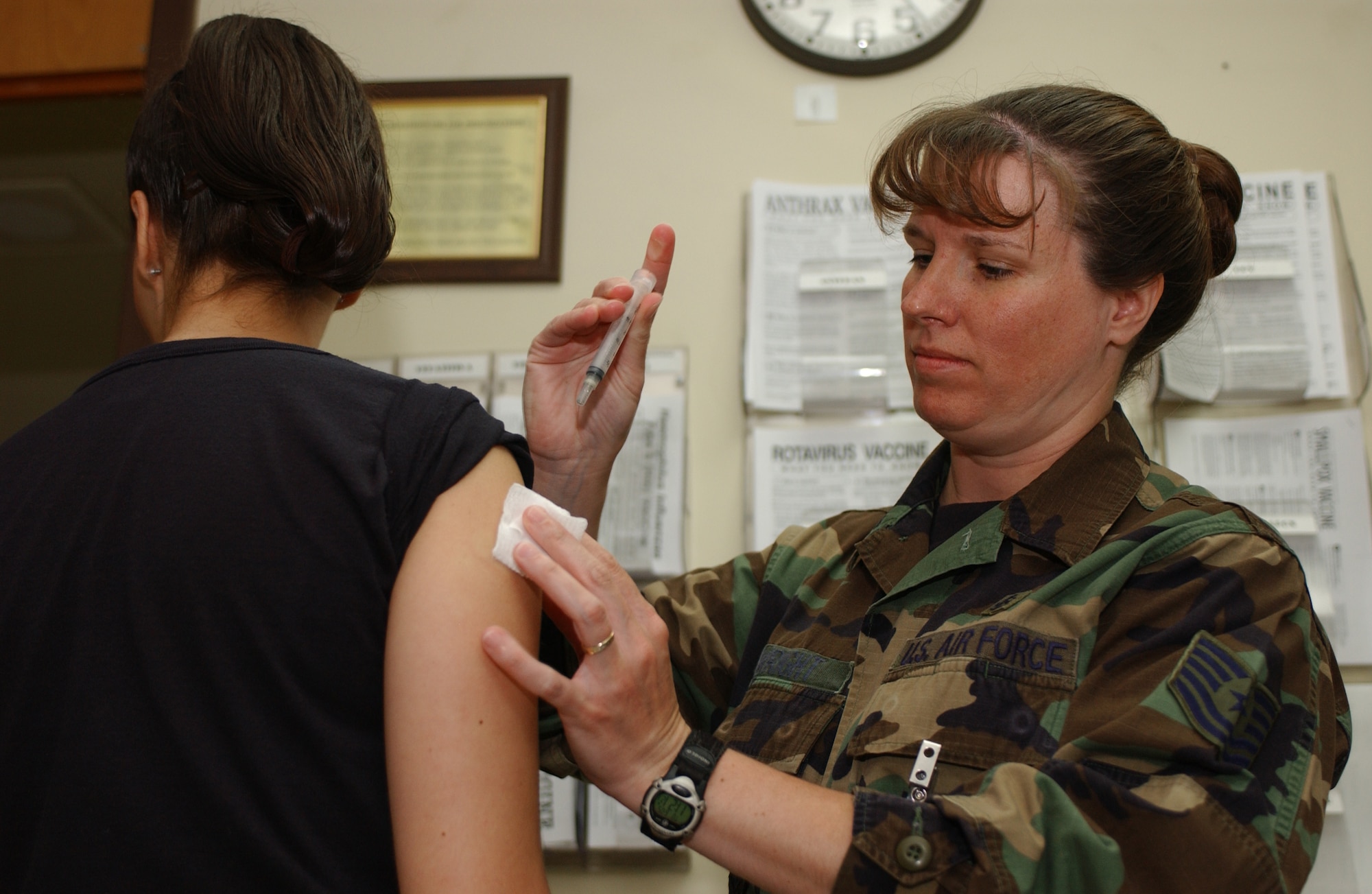 Osan Air Base, Republic of Korea -- U.S. Air Force Tech. Sgt. Shirley Wright (right), 51st Medical Operations Squadron administers Osan's 10,000th anthrax vaccine to Master Sgt. Nichole Reynolds, 51st Medical Operations Squadron, Tuesday at Osan.  Osan maintains an outstanding compliance and greatly contributes to Pacific Air Force being number one in the Air Force in anthrax vaccination compliance. 
(U.S. Air Force photo by Airman Jason Epley)