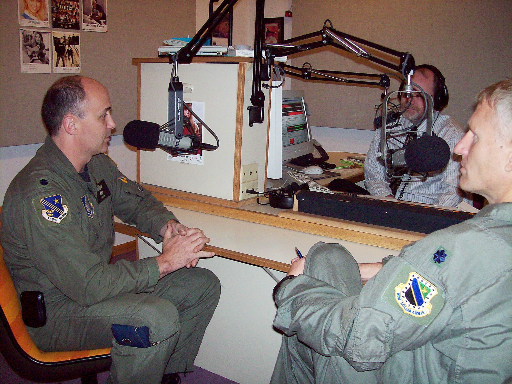 ELMENDORF AIR FORCE BASE, Alaska -- Lt. Col. Carlisle Lincoln talks to Tom Steigleman about the Alaska Air National Guard's involvement with the C-17 mission here during an interview on KAFC 93.7 FM Tuesday. The C-17 Globemaster III replaces the C-130 for the active duty at Elmendorf and is an additional mission for the Alaska ANG. Lt. Col. David Almand (also pictured) and Colonel Lincoln are the commanders for the 517th and 249th Airlift squadrons, respectively. (U.S. Air Force photo by Staff Sgt. Francesca Popp)