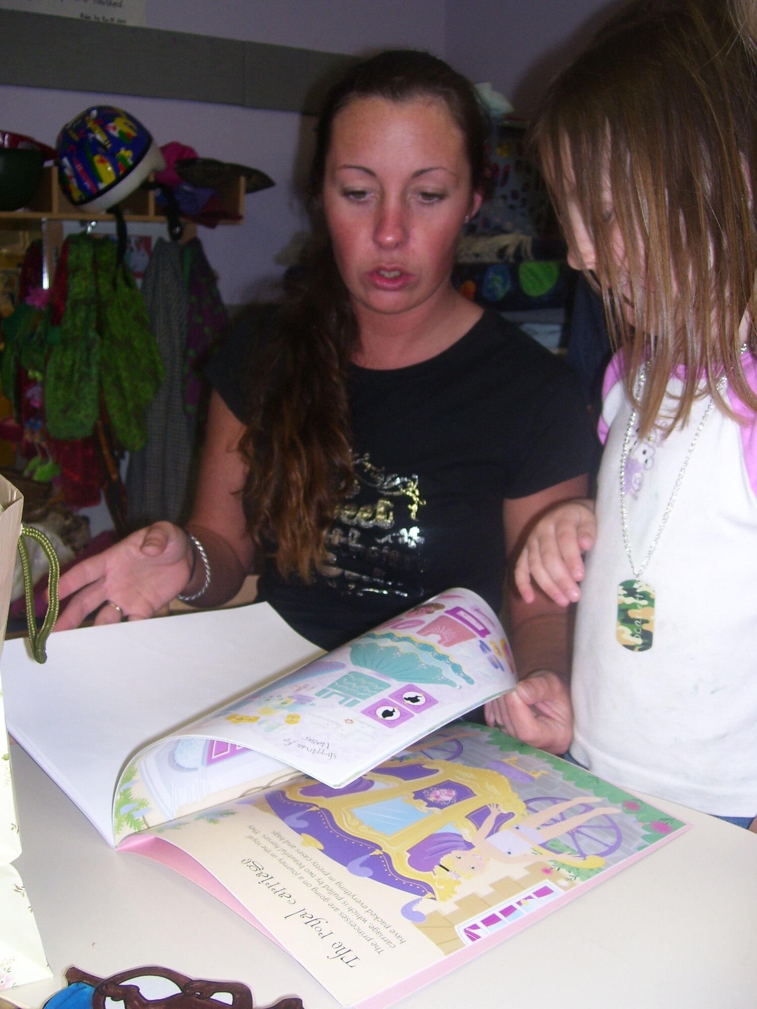 Airman 1st Class Mandy Bryan, 509th Comptroller Squadron, reads a book with her daughter Scarlet Howard. 

The Child Development Center, along with the Parent Advisory Board, held Parent Literacy Night May 21 for all families enrolled in the center.  Activities centered on how parents can promote literacy for children ages 6 weeks to 5 years. (Photo courtesy of Samantha Jacobs)
