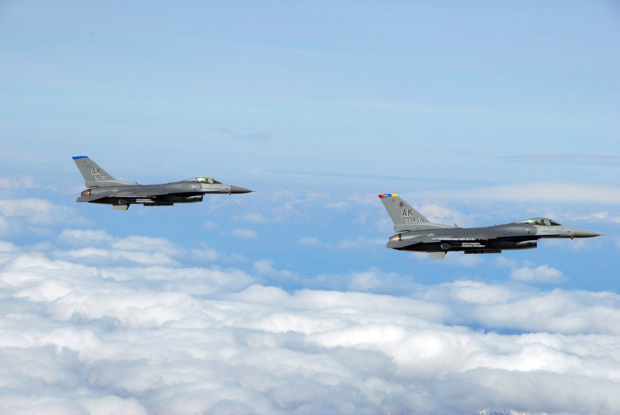 EIELSON AIR FORCE BASE, Alaska -- Two F-16 Fighting Falcons from the 18th Fighter Squadron, Alaska Air National Guard, fly over the Pacific Alaska Range Complex on May 29, 2007.  The two aircraft assigned to Eielson flew in formation for the last time due to the deactivation of the 355th FS, and the 18th FS.  (U.S. Air Force photo by Master Sergeant Rob Wieland) 
