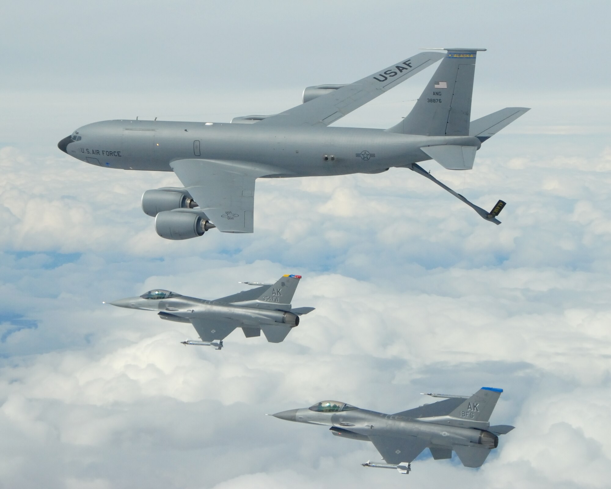 EIELSON AIR FORCE BASE, Alaska -- A KC-135R Stratotanker, 168th Air Refueling Wing, Alaska Air National Guard, refuels two F-16 Fighting Falcons from the 18th Fighter Squadron over the Pacific Alaska Range Complex on May 29, 2007.  The three aircraft assigned to Eielson flew in formation for the last time due to the deactivation of the 355th FS, and the 18th FS.  (U.S. Air Force photo by Master Sergeant Rob Wieland) 