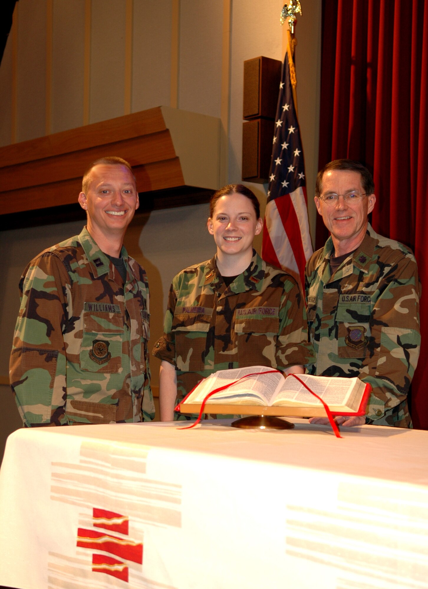 FAIRCHILD AIR FORCE BASE, Wash. -- Chaplain candidate, 2nd Lt. Nicole Palmeira, stands alongside Chaplain (Capt.) Mark Williams and Wing Chaplain (Lt. Col.) Jeffrey Neuberger on the alter at the base chapel. Both chaplains have played a role in guiding the candidate toward chaplaincy. The lieutenant will soon complete her tour here, one of the two required tours for a chaplain candidate. (U.S. Air Force photo/ Airman 1st Class Kali L. Gradishar)