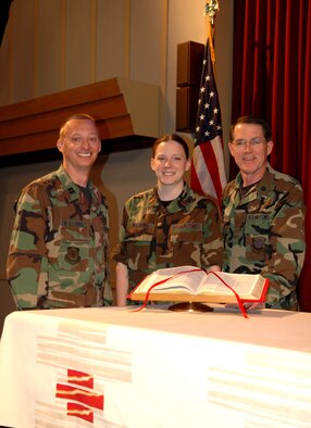 FAIRCHILD AIR FORCE BASE, Wash. -- Chaplain candidate, 2nd Lt. Nicole Palmeira, stands alongside Chaplain (Capt.) Mark Williams and Wing Chaplain (Lt. Col.) Jeffrey Neuberger on the alter at the base chapel. Both chaplains have played a role in guiding the candidate toward chaplaincy. The lieutenant will soon complete her tour here, one of the two required tours for a chaplain candidate. (U.S. Air Force photo/ Airman 1st Class Kali L. Gradishar)