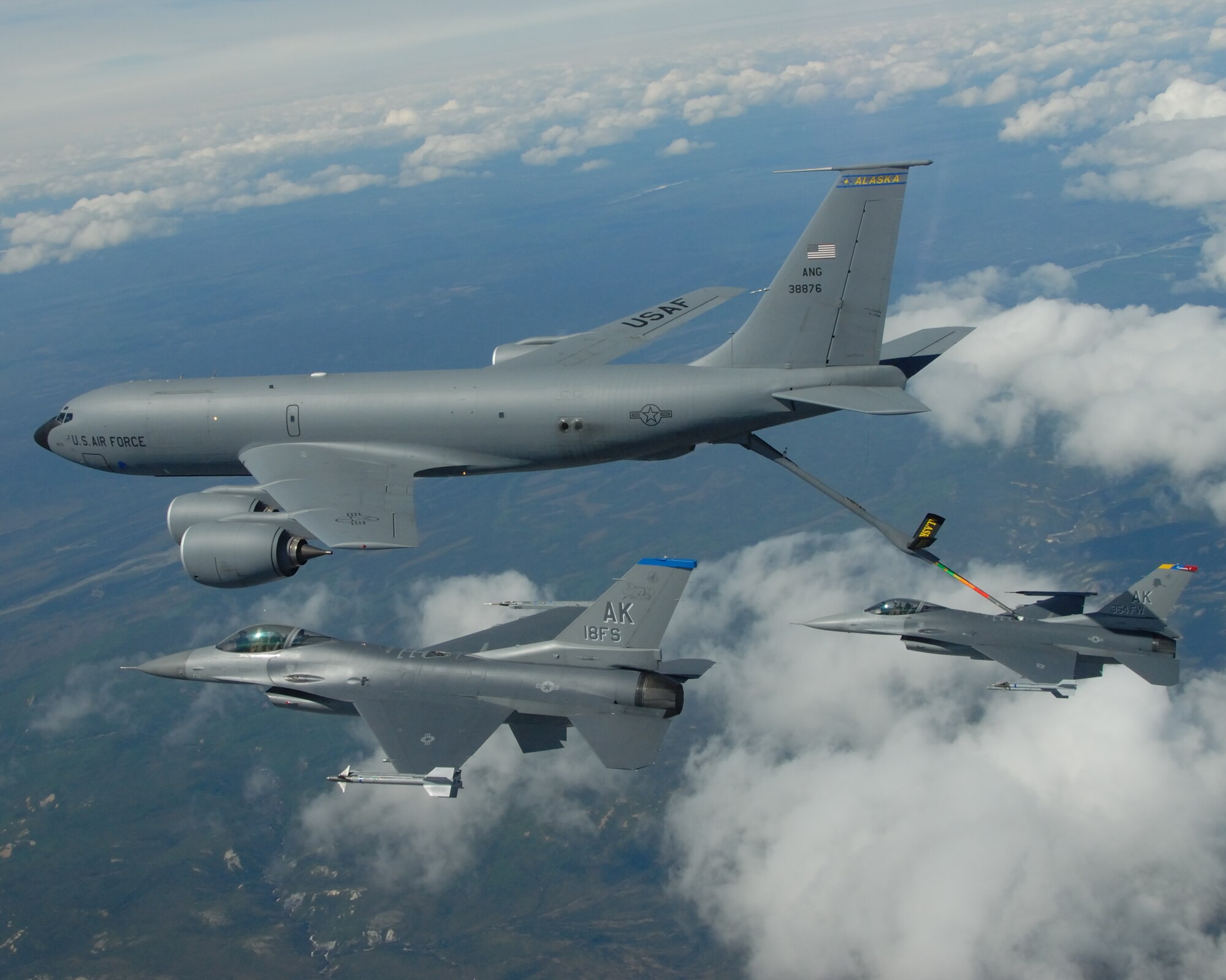 EIELSON AIR FORCE BASE, Alaska -- A KC-135R Stratotanker, 168th Air Refueling Wing, Alaska Air National Guard, refuels two F-16 Fighting Falcons from the 18th Fighter Squadron over the Pacific Alaska Range Complex May 29, 2007.  The three aircraft assigned to Eielson flew in formation for the last time due to the deactivation of the 355th FS, and the 18th FS.  (U.S. Air Force photo by Master Sergeant Rob Wieland) 