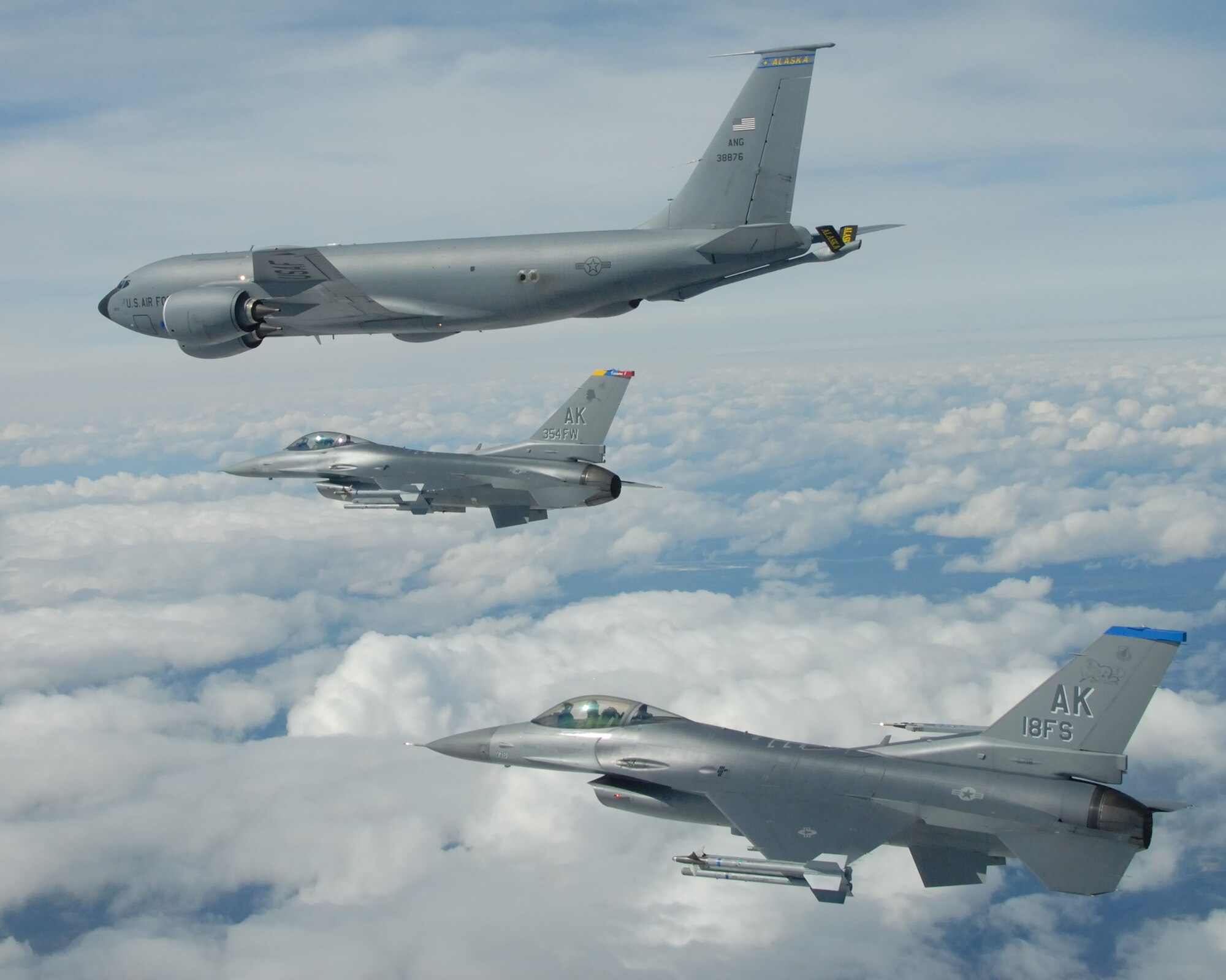 EIELSON AIR FORCE BASE, Alaska -- A KC-135R Stratotanker, 168th Air Refueling Wing, Alaska Air National Guard, flies in formation with a F-16 Fighting Falcon from the 18th Fighter Squadron May 29, 2007.  The three aircraft assigned to Eielson flew in formation for the last time due to the deactivation of the 355th FS, and the 18th FS.  (U.S. Air Force photo by Master Sergeant Rob Wieland) 