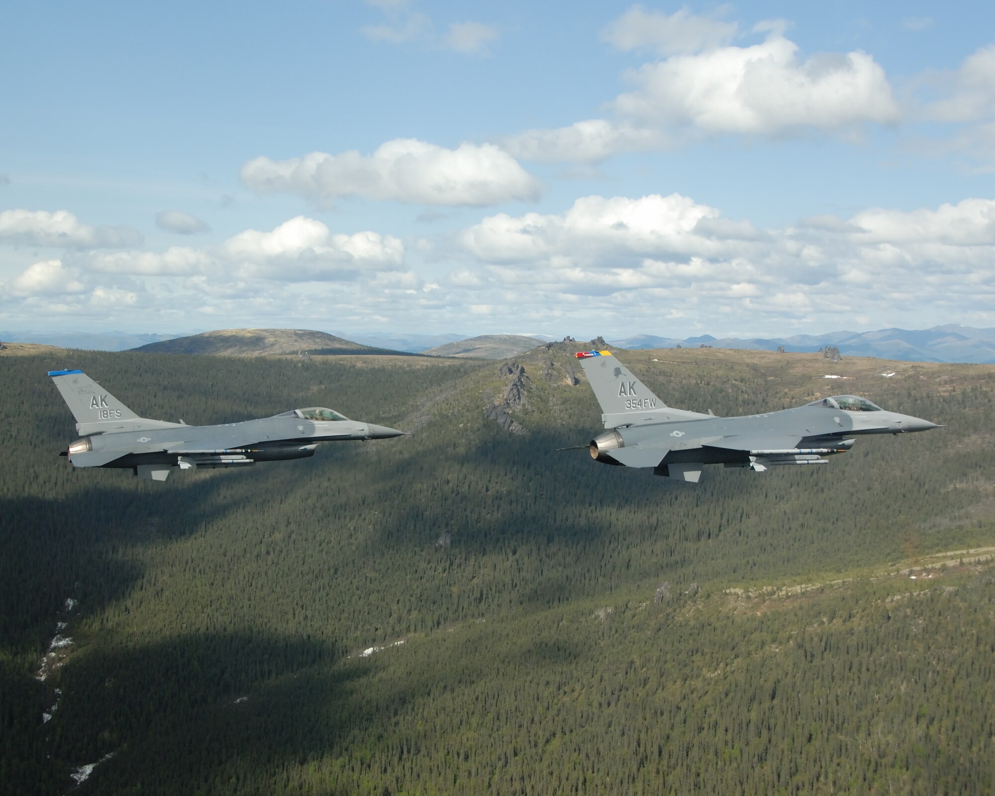 EIELSON AIR FORCE BASE, Alaska -- Two F-16 Fighting Falcons from the 18th Fighter Squadron fly over the Pacific Alaska Range Complex on May 29, 2007.  The aircraft assigned to Eielson flew in formation for the last time due to the deactivation of the 355th FS, and the 18th FS.  (U.S. Air Force photo by Master Sergeant Rob Wieland) 

