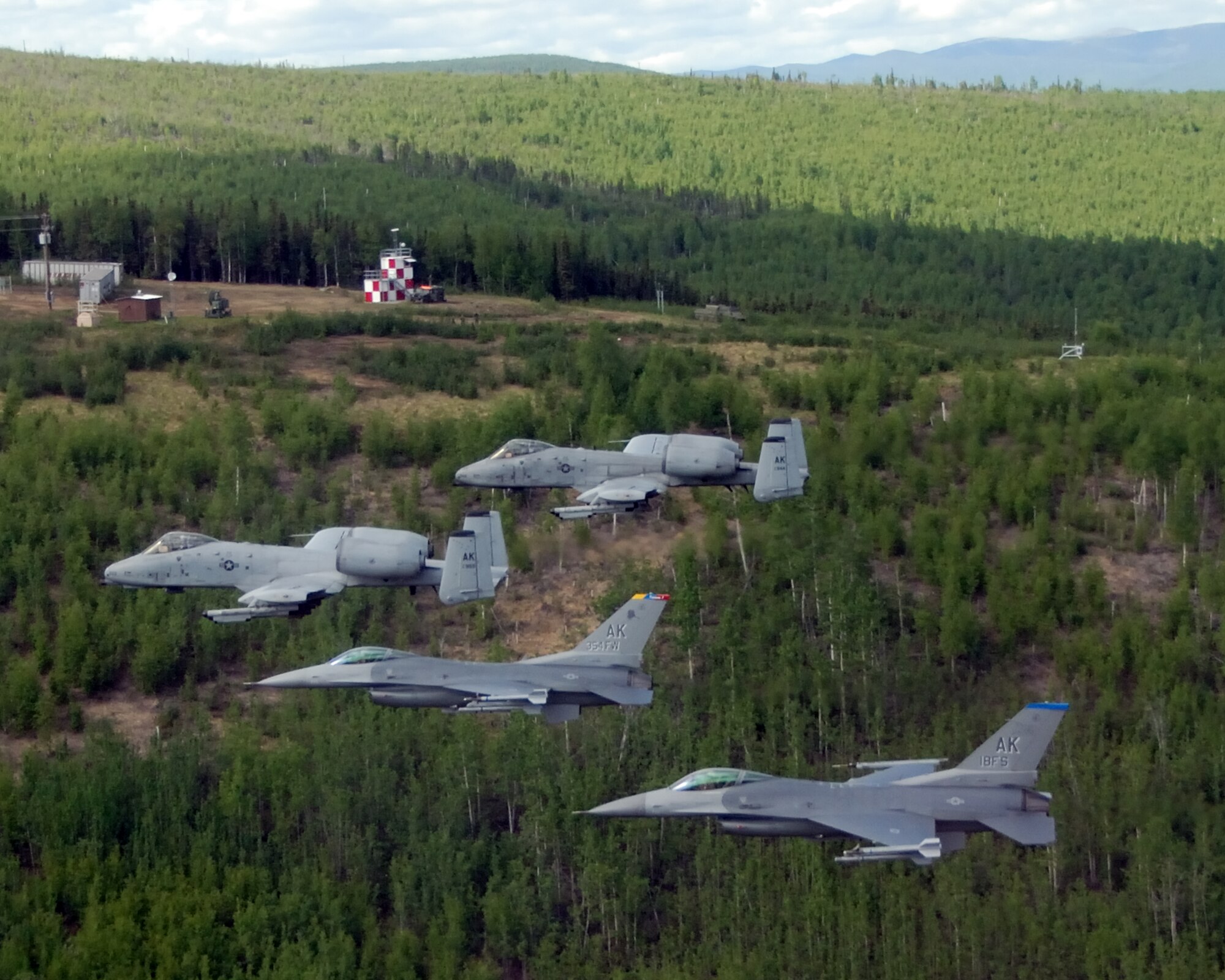 EIELSON AIR FORCE BASE, Alaska --  Joint Terminal Attack Controllers (JTAC) from the 3rd Air Support Operations Squadron, control two F-16 Fighting Falcons from the 18th Fighter Squadron, and two A-10 Wathog II's from the 355th Fighter Squadron May 29, 2007, over the Pacific Alaska Range Complex.  The aircraft assigned to Eielson flew in formation for the last time due to the deactivation of the 355th FS, and the 18th FS.  (U.S. Air Force photo by Master Sergeant Rob Wieland)