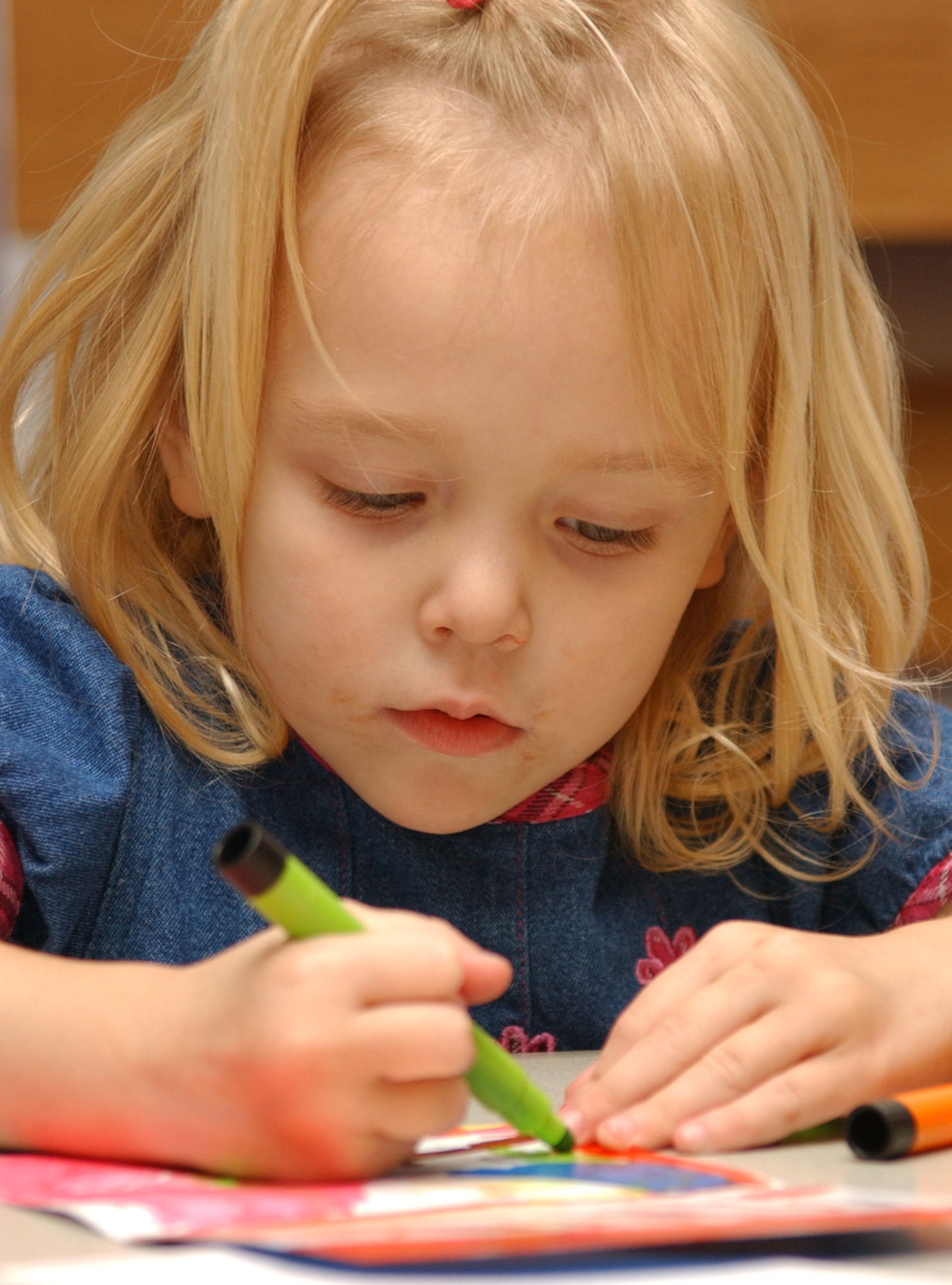 Chloe Chandler, 3, works on a card to send to her father, 1st Lt. Michael Chandler, who’s on a remote assignment to Kunsan Air Base, Korea.  Chloe and her mother, Sheila, took part in an arts and crafts night May 25 at the youth center for children whose parents are deployed.  The event was sponsored by the airman and family readiness center.  (U. S. Air force photo by Kemberly Groue)