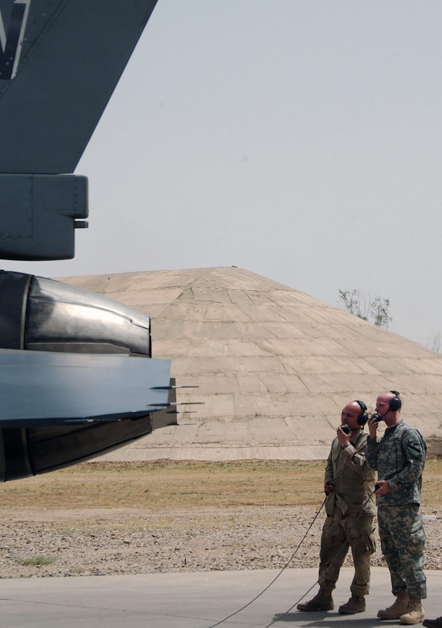 Staff Sgt. Samuel Martin (right) shows his brother, Army Sgt. Paul Martin, how he performs a maintenance check on an F-16 Fighting Falcon jet engine run inspection May 30 at Balad Air Base, Iraq. Sergeant Samuel Martin is assigned to the 14th Air Expeditionary Maintenance Unit and Sergeant Paul Martin is a satellite imagery analyst with the 3rd Brigade, 1st Calvary Division from Fort Hood, Texas. The Airman got a chance to meet his brother who was passing through with his Army unit on the way to Camp Victory, Iraq. (U.S Air Force photo/Staff Sgt. LuCelia Ball)
