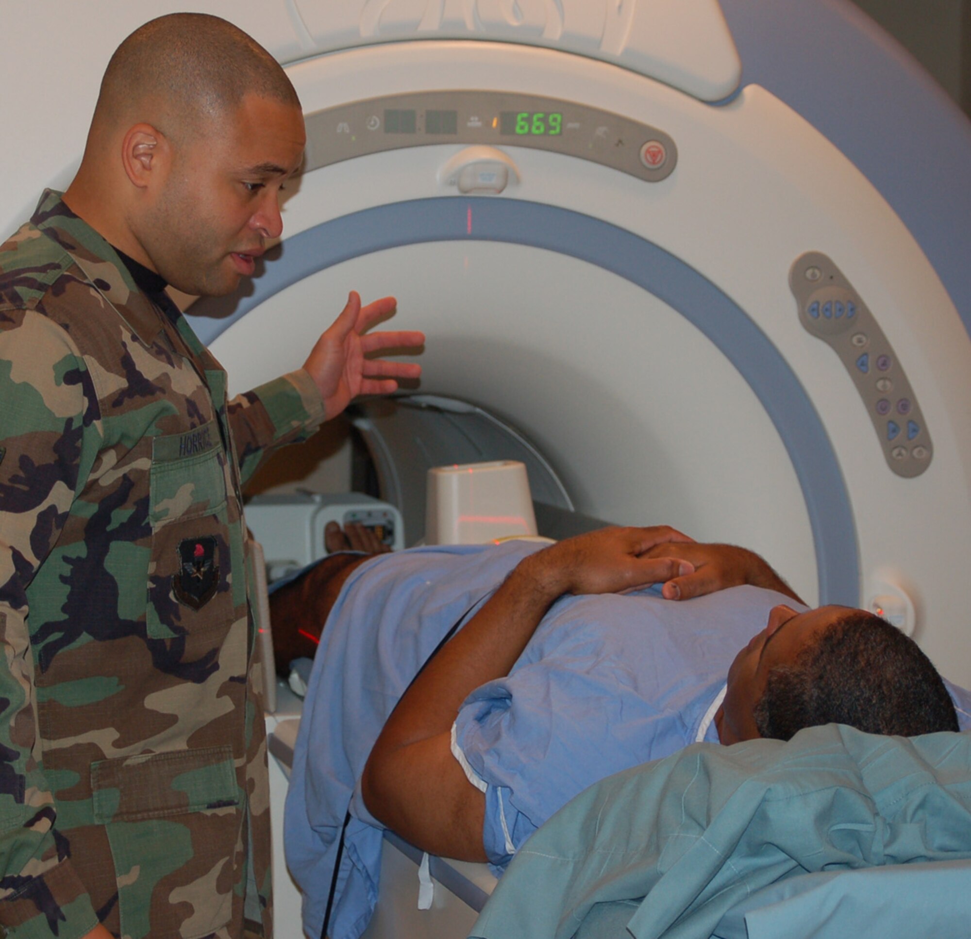 Staff Sgt. Venton Horrice, MRI technician, explains how the system produces images to patient Maj. Peter Galindez, 81st Medical Group, before beginning the scan procedure.  (U.S. Air Force photo by Steve Pivnick)