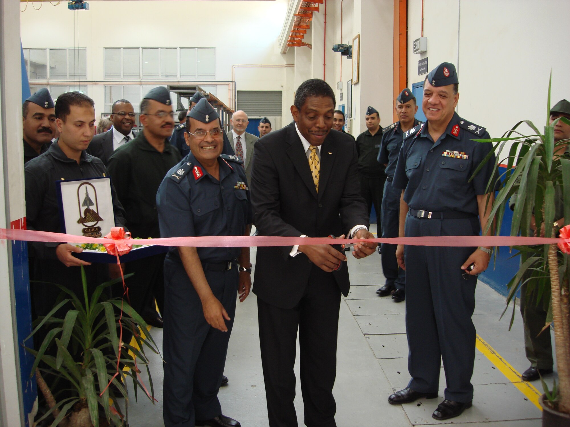 Larry Jones, center, Pratt and Whitney vice president for Military Customer Support, cuts the ribbon to activate the Egyptian air force F100 Engine Depot in Helwan, Egypt. Pictured with him are Maj. Gen. Magdy Gamal, left, Helwan Depot commander, and Maj. Gen. Said Mabrouk, right, chief of the Egyptian air force engineering department. 