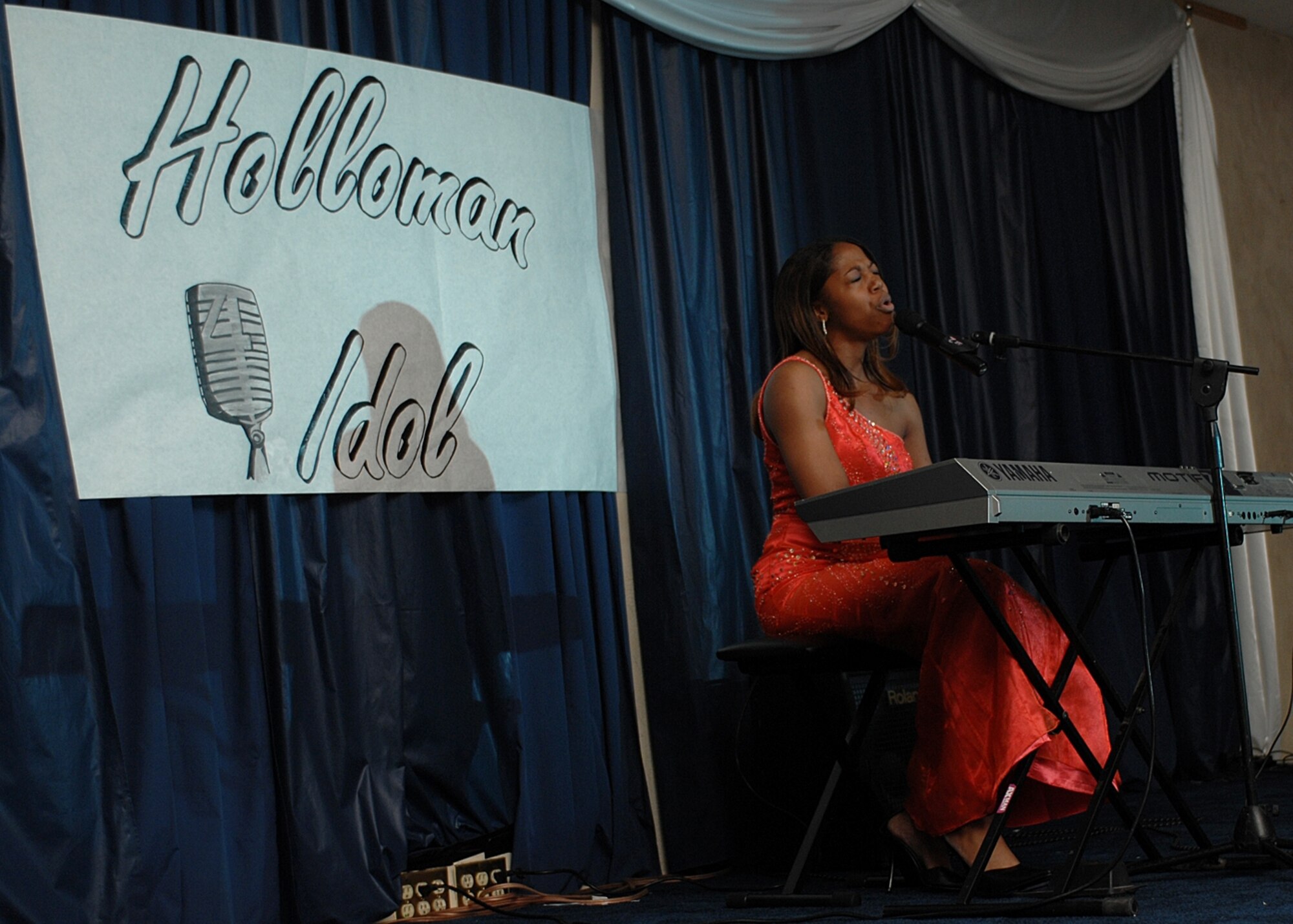 Ashley James sings and plays the piano in front of more than 400 audience members at Holloman Idol. She got second plane in the competition. (U.S. Air Force photo/Airman 1st Class John Strong)
