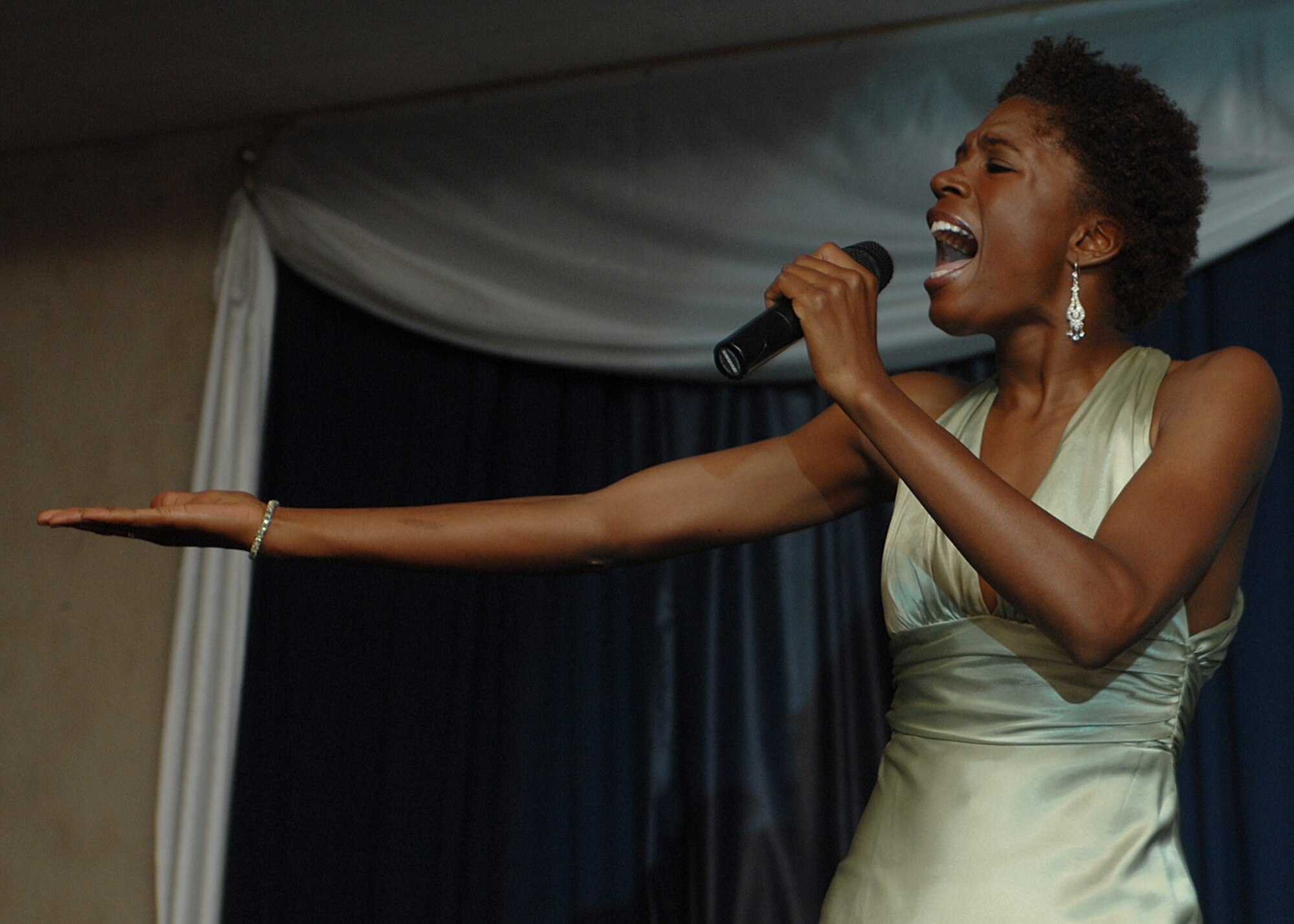 Senior Airman Joshica Kiah, Materiel Maintenance Support Squadron, sings in front of more than 400 audience members at Holloman Idol. Airman Kiah got second place in the competition. (U.S. Air Force photo/Airman 1st Class John Strong)