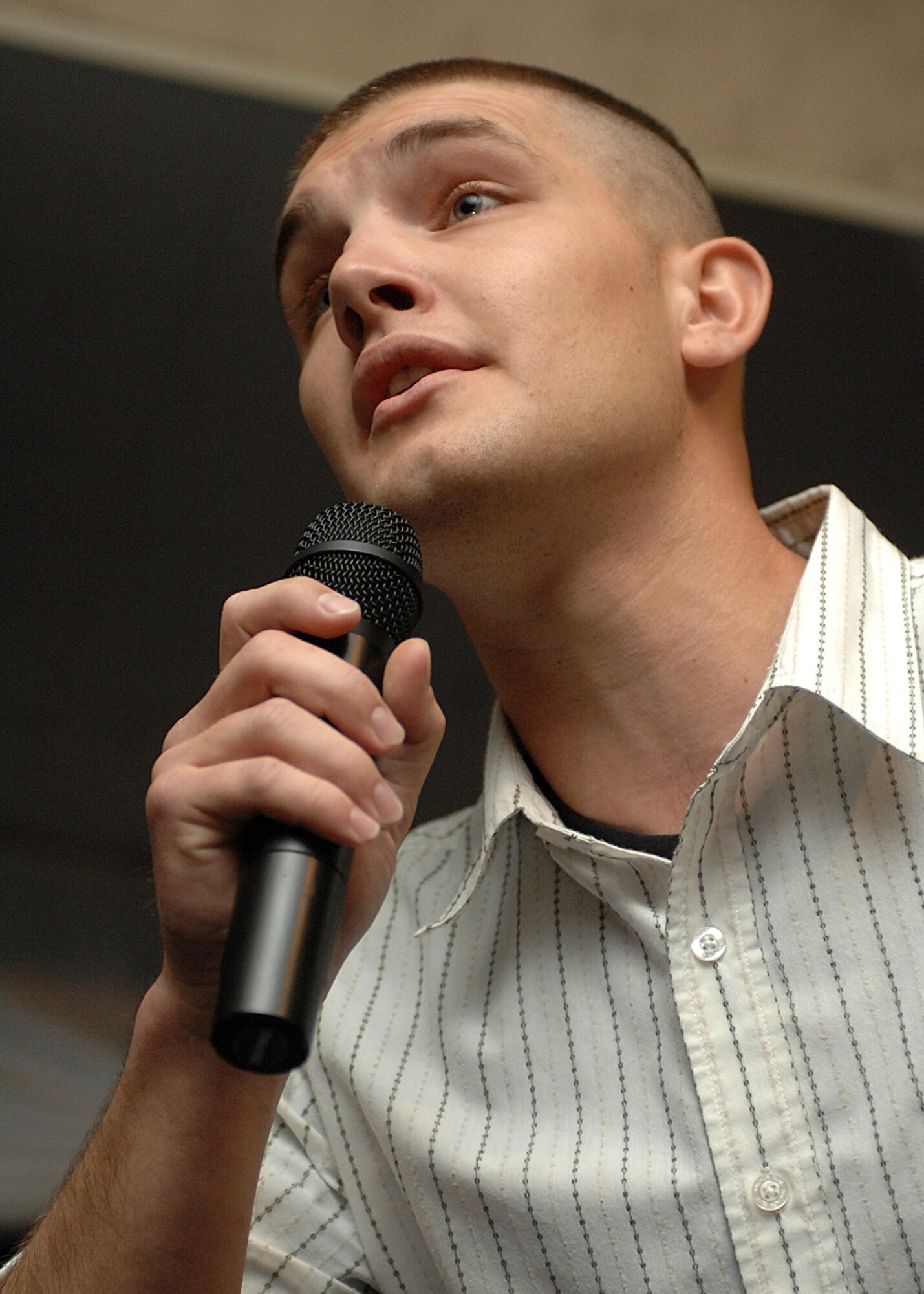 Senior Airman Brandon McDonald, 49th Civil Engineer Squadron sings a Tim McGraw song to the more than 400 audience members at Holloman Idol. (U.S. Air Force photo/Airman 1st Class John Strong)