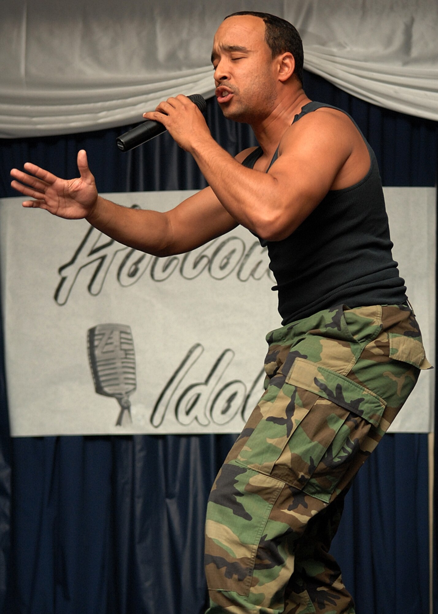 Staff Sgt. Seneca Linder, 49th Communications Squadron, sings "What kind of Soldier are you?" to the more than 400 audience members at Holloman Idol. (U.S. Air Force photo/Airman 1st Class John Strong)