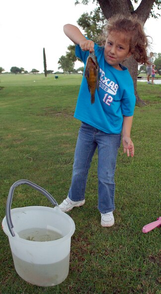 LAUGHLIN AIR FORCE BASE, Texas -- Allie Clark, 5, daughter of Col. Dan Laro Clark, 47th Flying Training Wing vice commander, proudly shows off her third catch of the 4th Annual Laughlin Fishing Derby.  (U.S. Air Force photo by Staff Sgt. Austin M. May)
