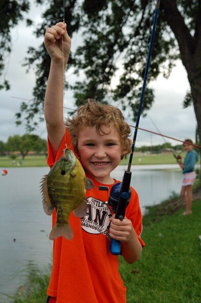 LAUGHLIN AIR FORCE BASE, Texas -- Michael Thompson, 6, son of Lt. Col. Garrett Thompson, 47th Operations Group, displays his first catch of the day.  (U.S. Air Force photo by Staff Sgt. Austin M. May)