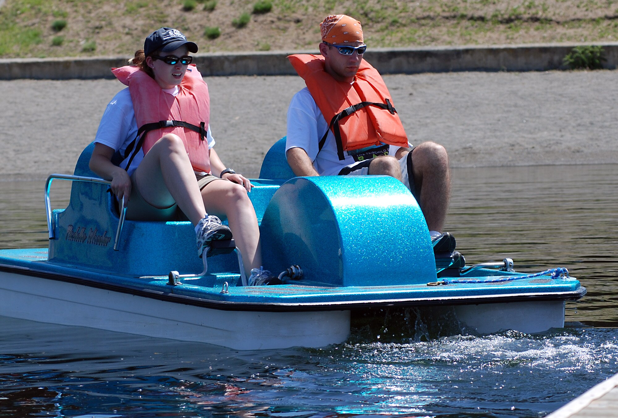 FAIRCHILD AIR FORCE BASE, Wash. -- 1st Lt. Mark Struska, 92nd Operation Support Squadron airfield operation flight operations officer, with wife, Alison, paddle a boat on Clear Lake during one of the challenges of the Great Race June 1. The winners of the race, “The Old Wizards” team   , were announced at the Wing MatchUP Picnic later in the day. (U.S. Air Force photo/ Tech. Sgt. Larry W. Carpenter Jr.)