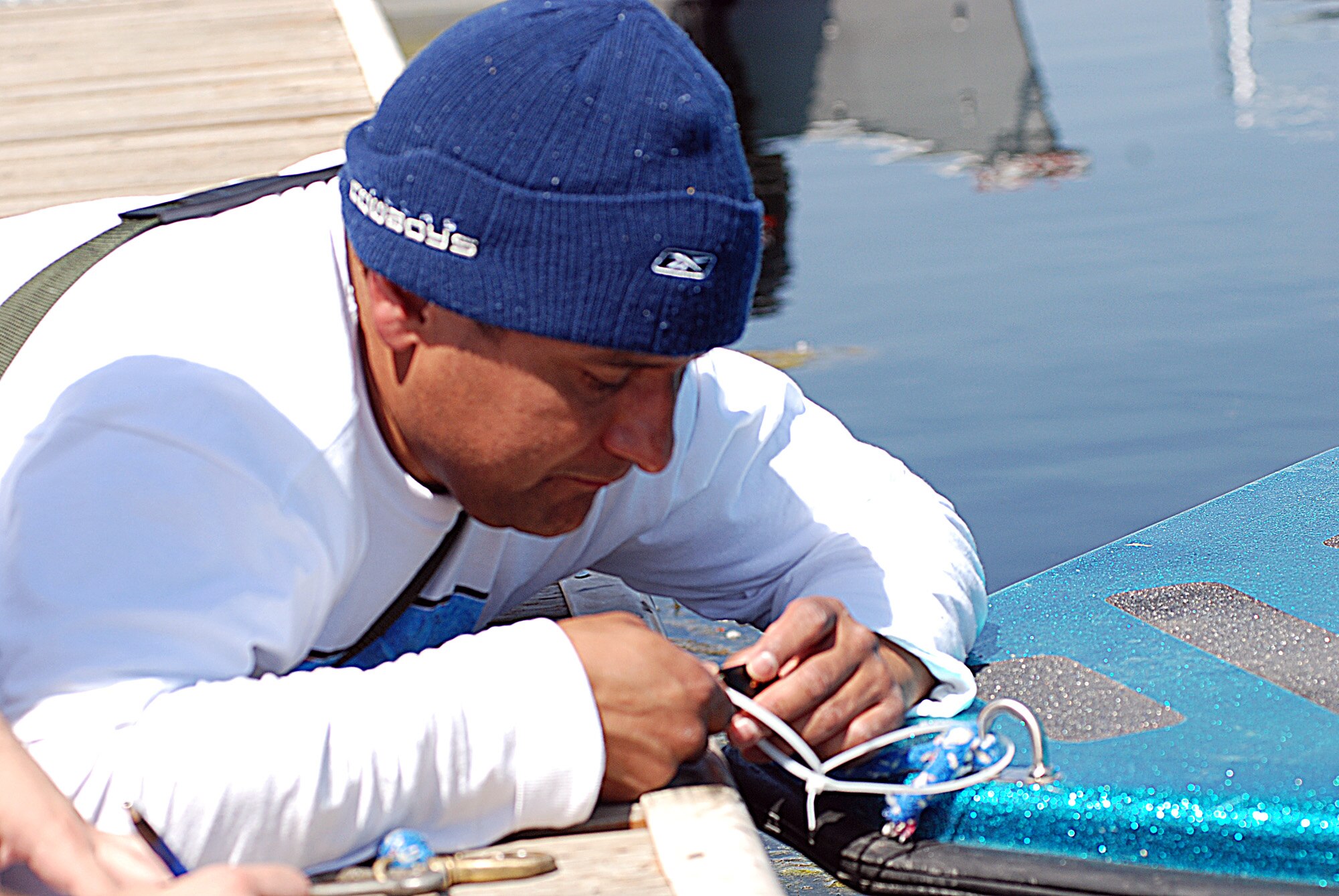 FAIRCHILD AIR FORCE BASE, Wash. -- Tech. Sgt. Pedro Lozano, 92nd Operation Support Squadron combat crew communications, attempts to open a padlock without knowing the combination to continue on with his partner at Clear Lake in hope of winning Fairchild’s Great Race June 1. The teams were given four numbers from which they could only use three to formulate the correct combination to open one of five locks. (U.S. Air Force photo/ Tech. Sgt. Larry W. Carpenter Jr.)