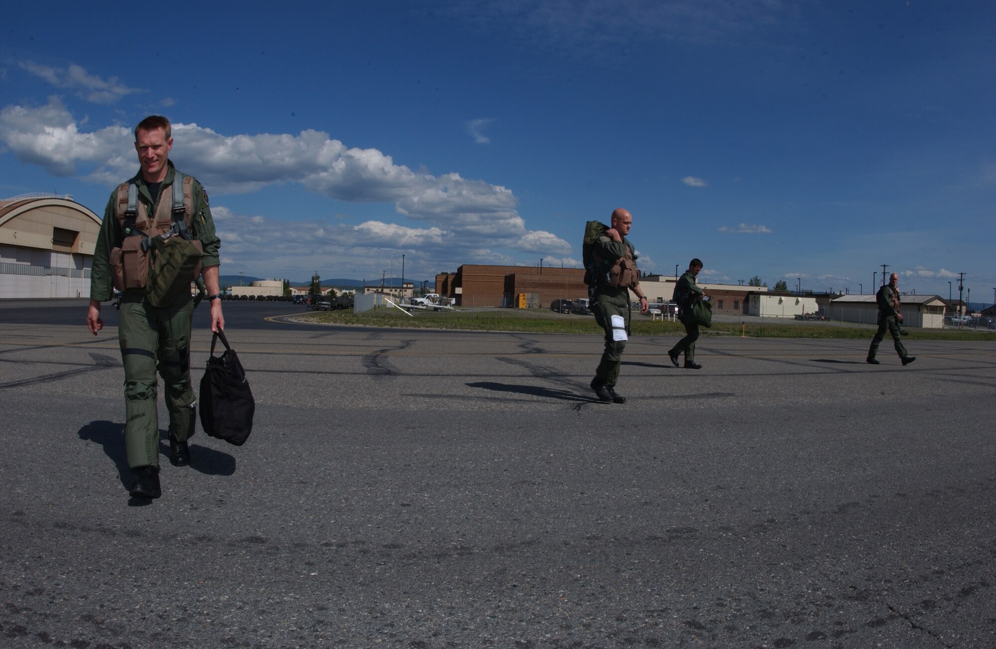 EIELSON AIR FORCE BASE, Alaska -- Four F-16 Fighting Falcon pilots from the 555th Fighter Squadron, Aviano Air Base, Italy, step to their jets prior to a mission for Red Flag-Alaska 07-2 June 4 here. RF-A 07-2 is a Pacific Air Forces-directed field training exercise for U.S. and coalition forces flown under simulated air-combat conditions. It is conducted on the Pacific Alaska Range Complex with air operations flown out of Eielson and Elmendorf Air Force Bases. (U.S. Air Force Photo by Airman 1st Class Jonathan Snyder) 